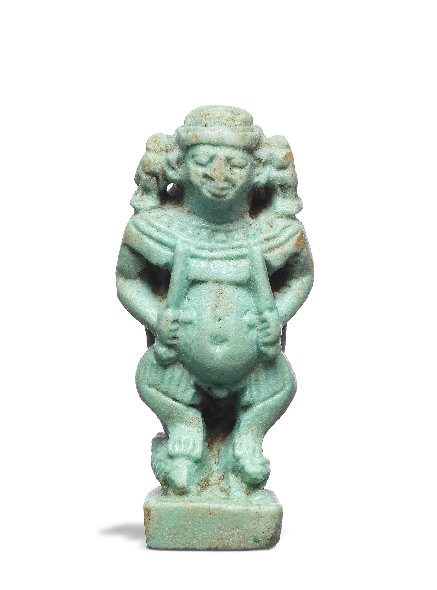 Appraisal: AN EGYPTIAN BLUE-GREEN GLAZED FAIENCE AMULET OF PATAIKOS An Egyptian