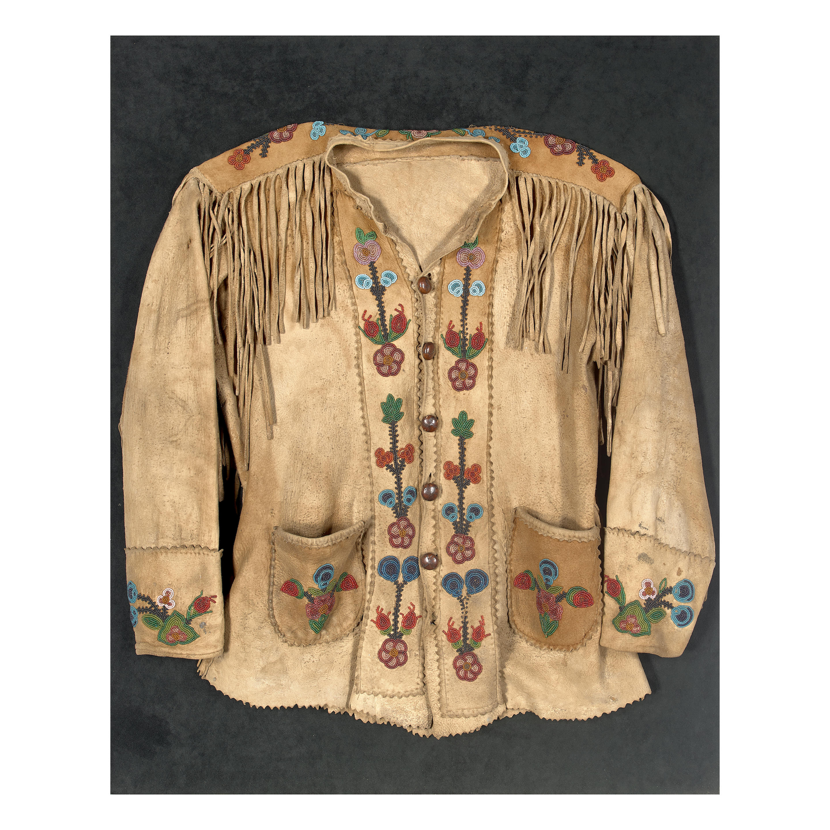 Appraisal: A PLATEAU BEADED JACKET Of hide construction with fringe at