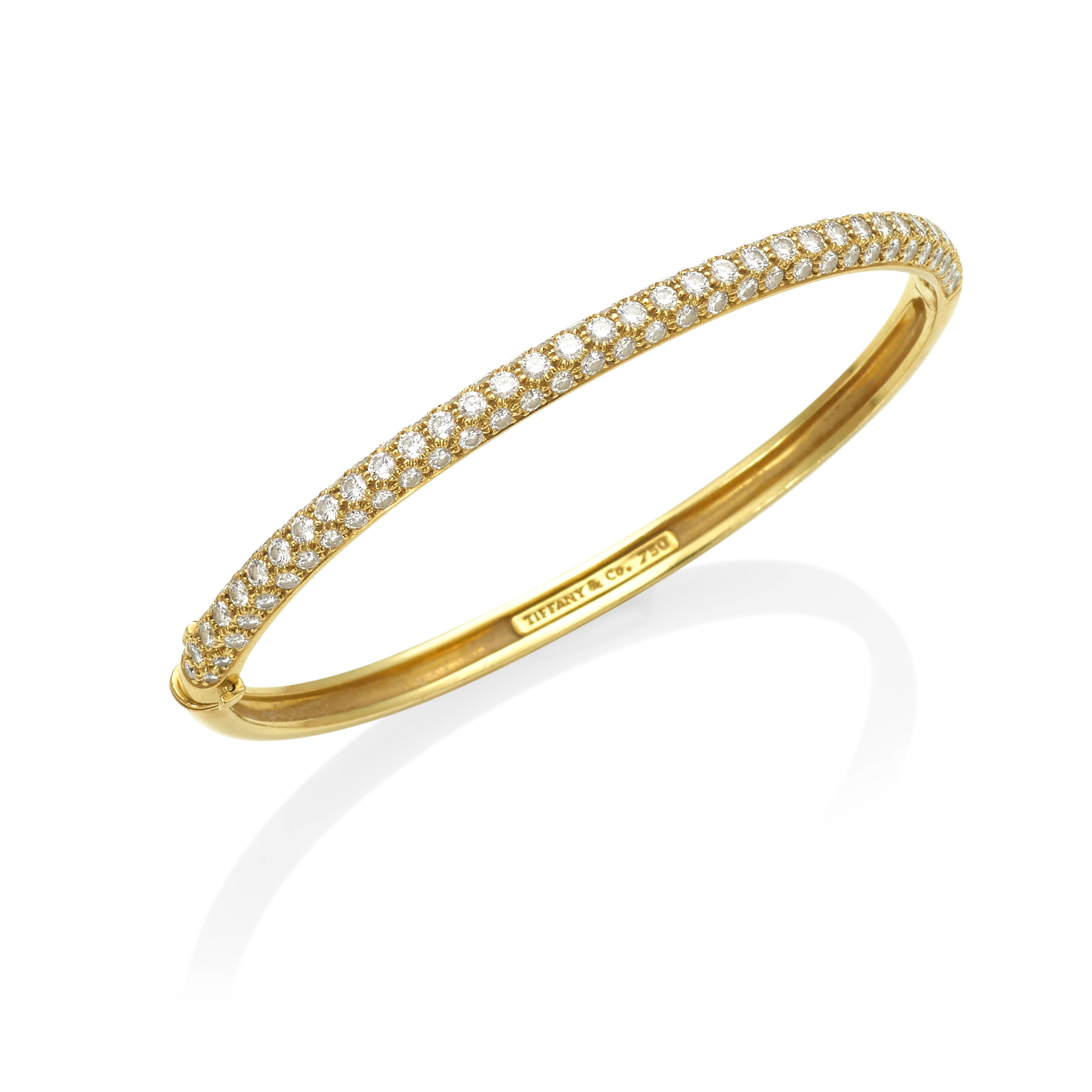 Appraisal: TIFFANY CO AN K GOLD AND DIAMOND HINGED BANGLE Featuring