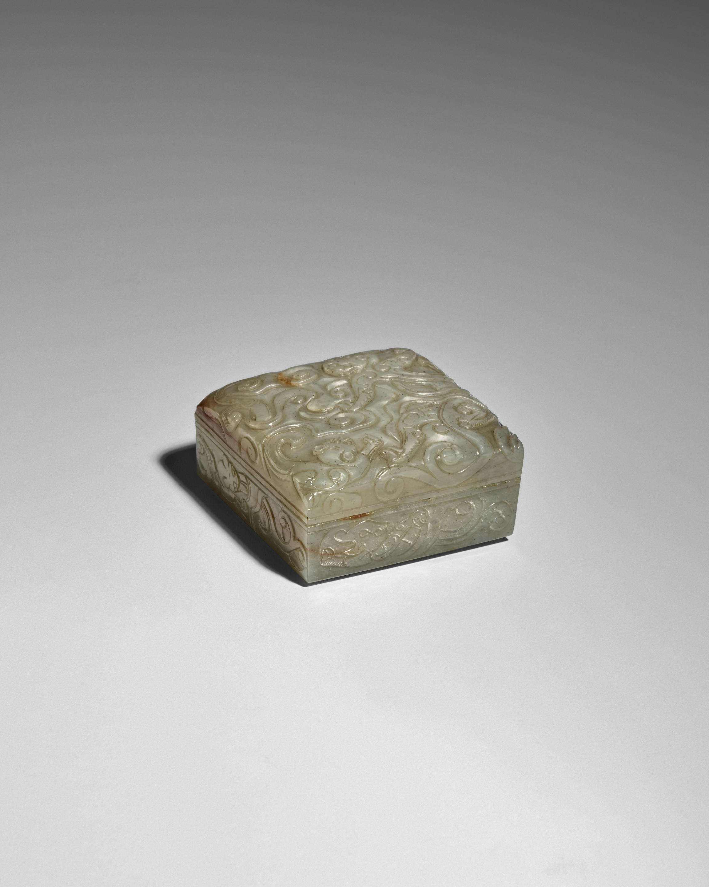 Appraisal: AN ARCHAISTIC JADE DRAGON-IN-CLOUDS SQUARE BOX AND COVER Song-Ming dynasty