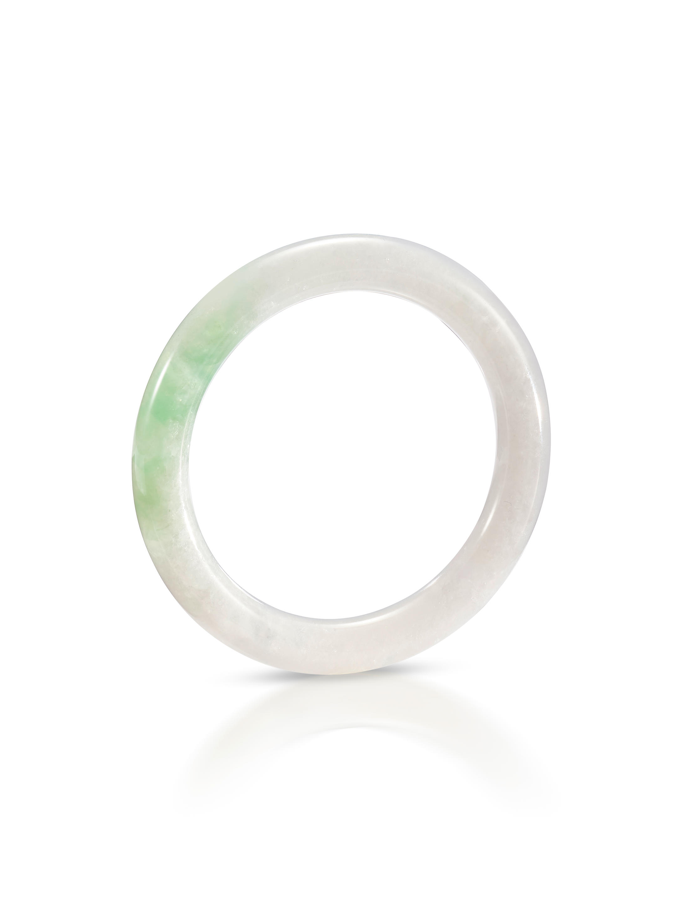 Appraisal: JADEITE BANGLE The translucent cylindrical jadeite bangle of soft celadon