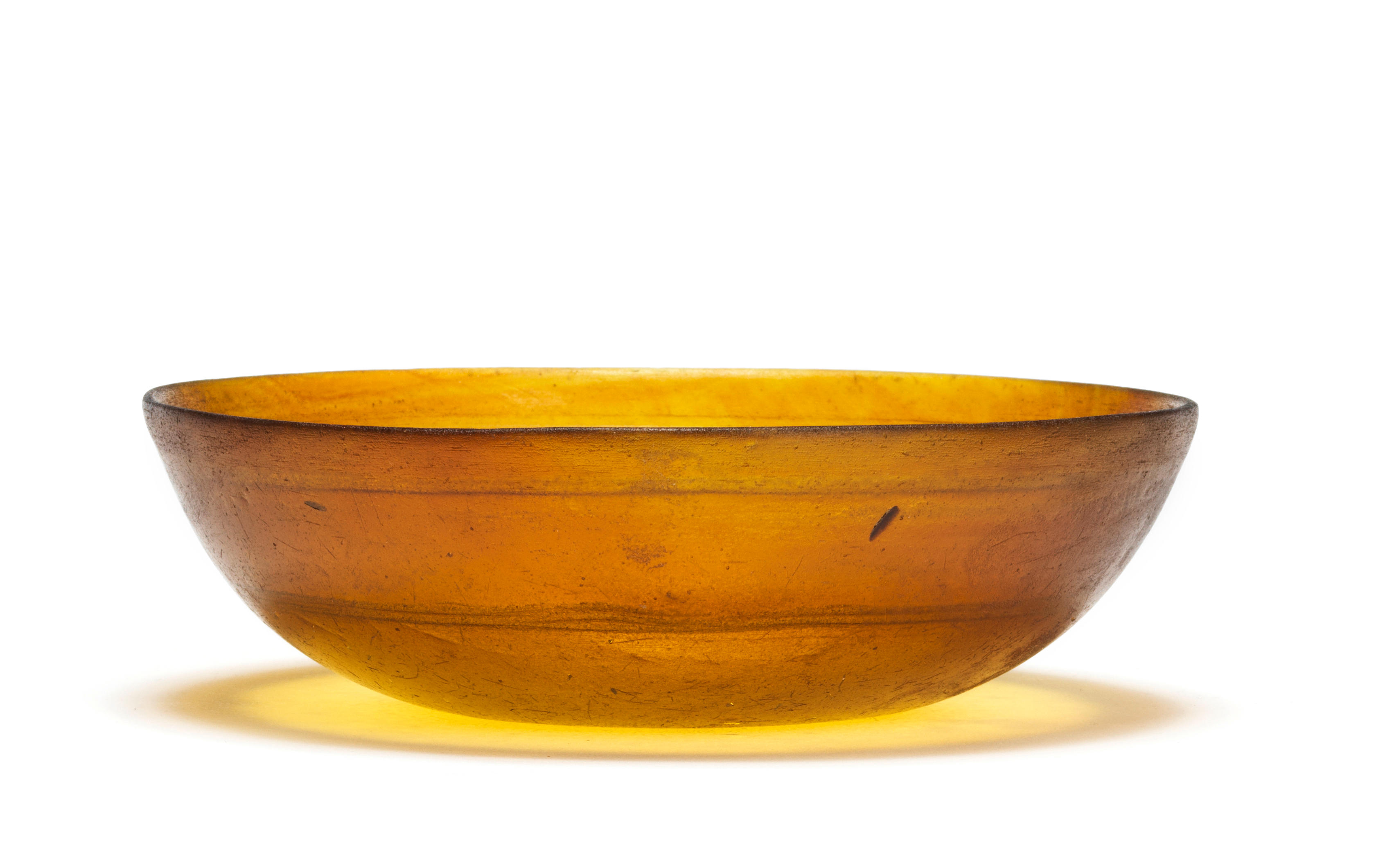 Appraisal: A ROMAN AMBER CAST GLASS BOWL WITH WHEEL-CUT BANDS A