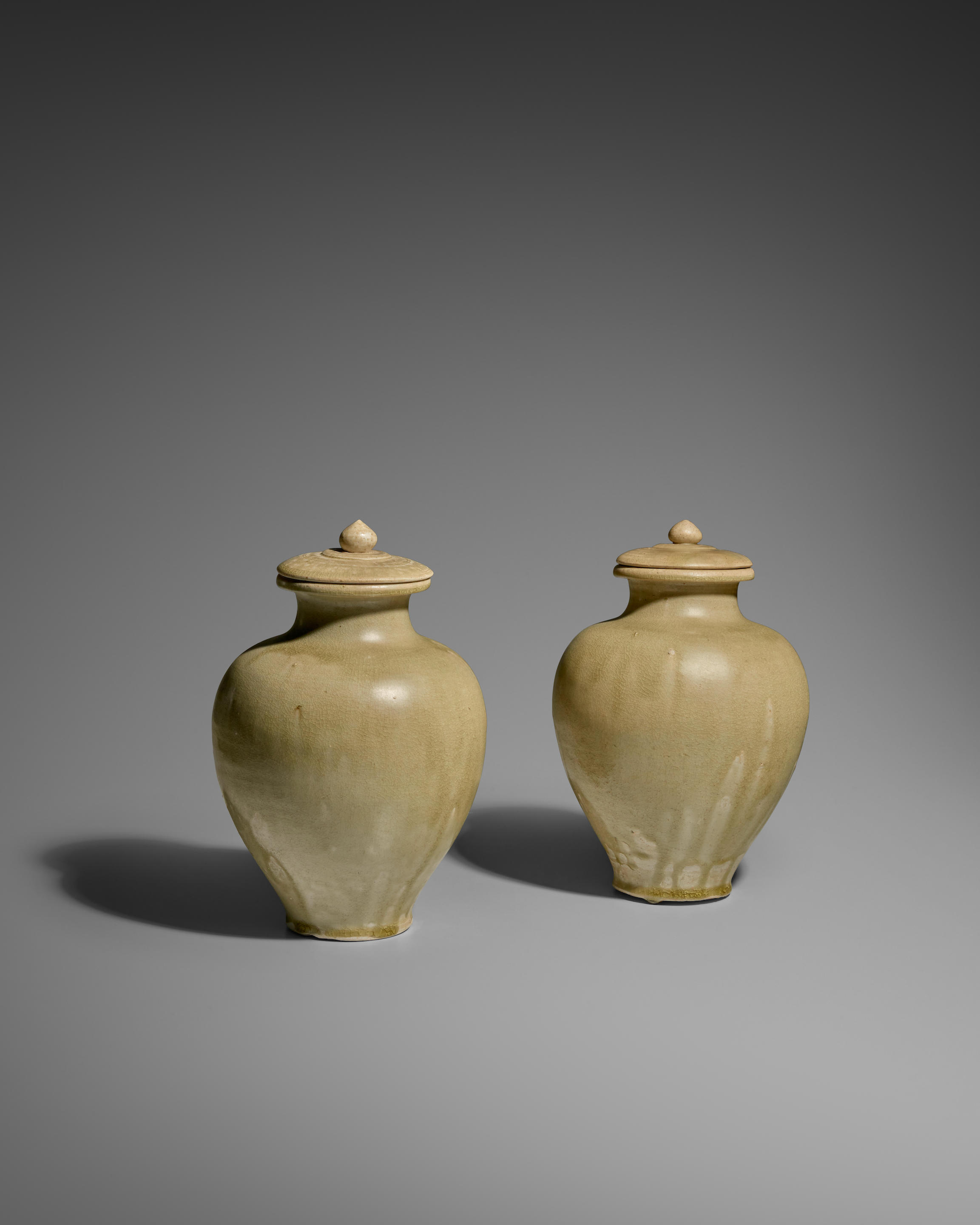 Appraisal: TWO GREEN GLAZED STONEWARE JARS AND COVERS Sui dynasty Each