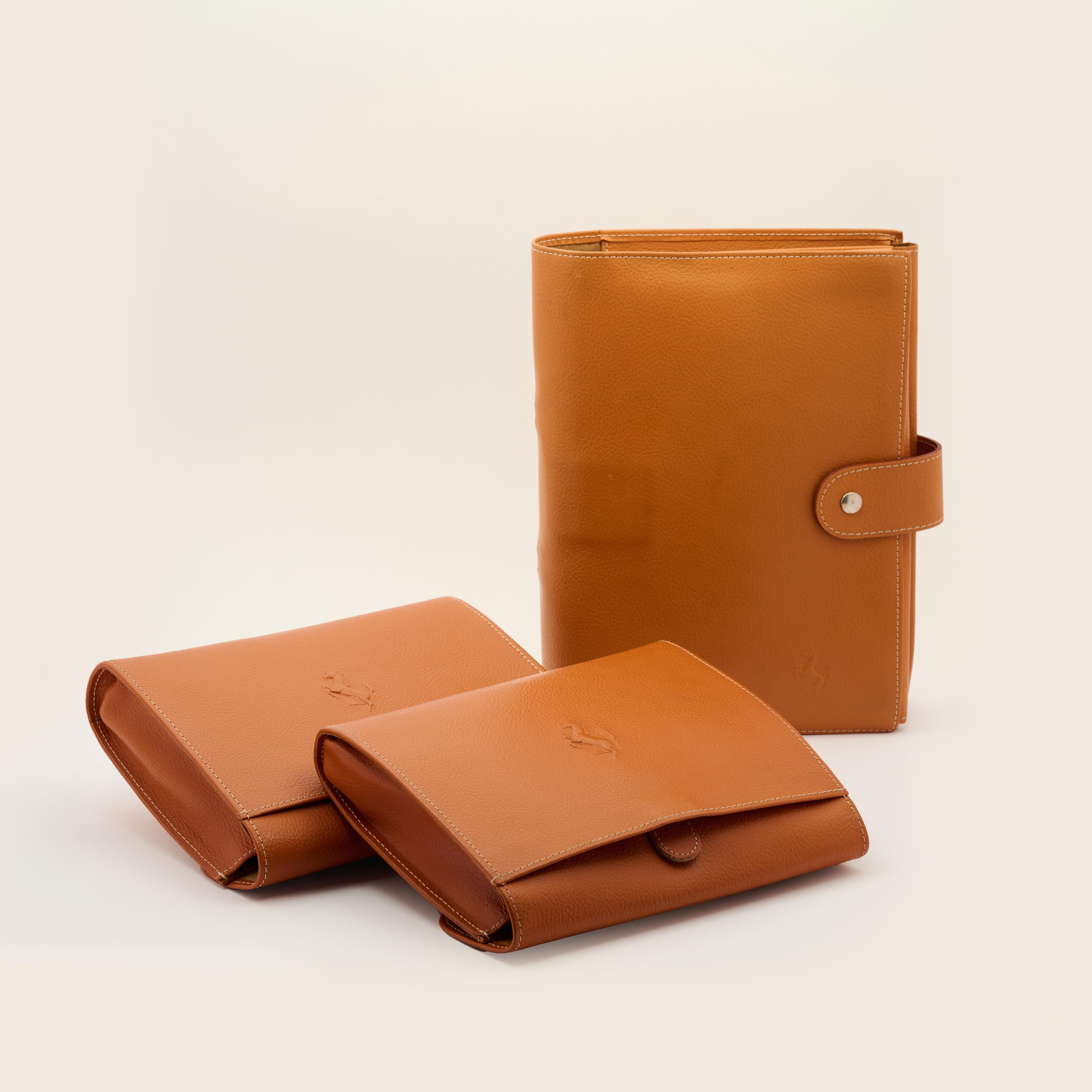 Appraisal: FERRARI POUCHES POCHETTES a set of three brown leather pouches