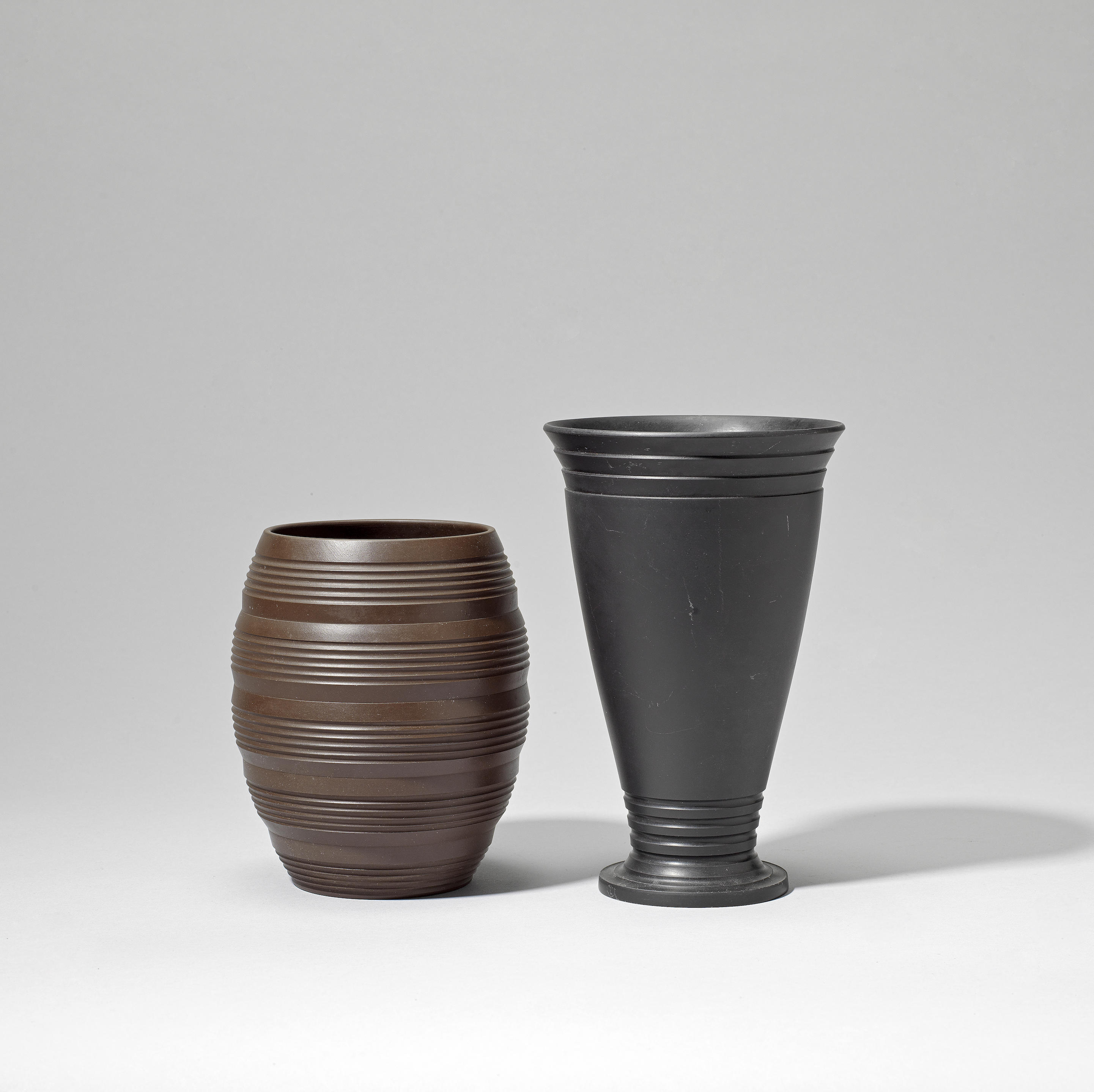 Appraisal: KEITH MURRAY MADE BY WEDGWOOD Two vases circa Earthenware brown