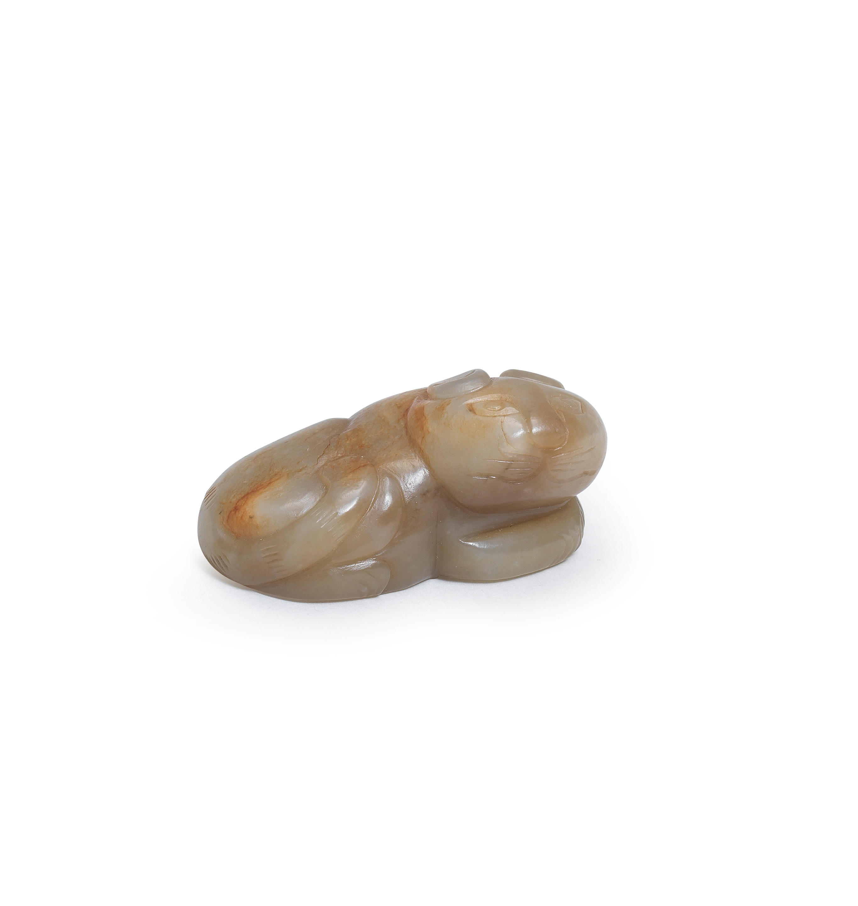 Appraisal: A PALE GREEN AND RUSSET JADE CARVING OF A CAT