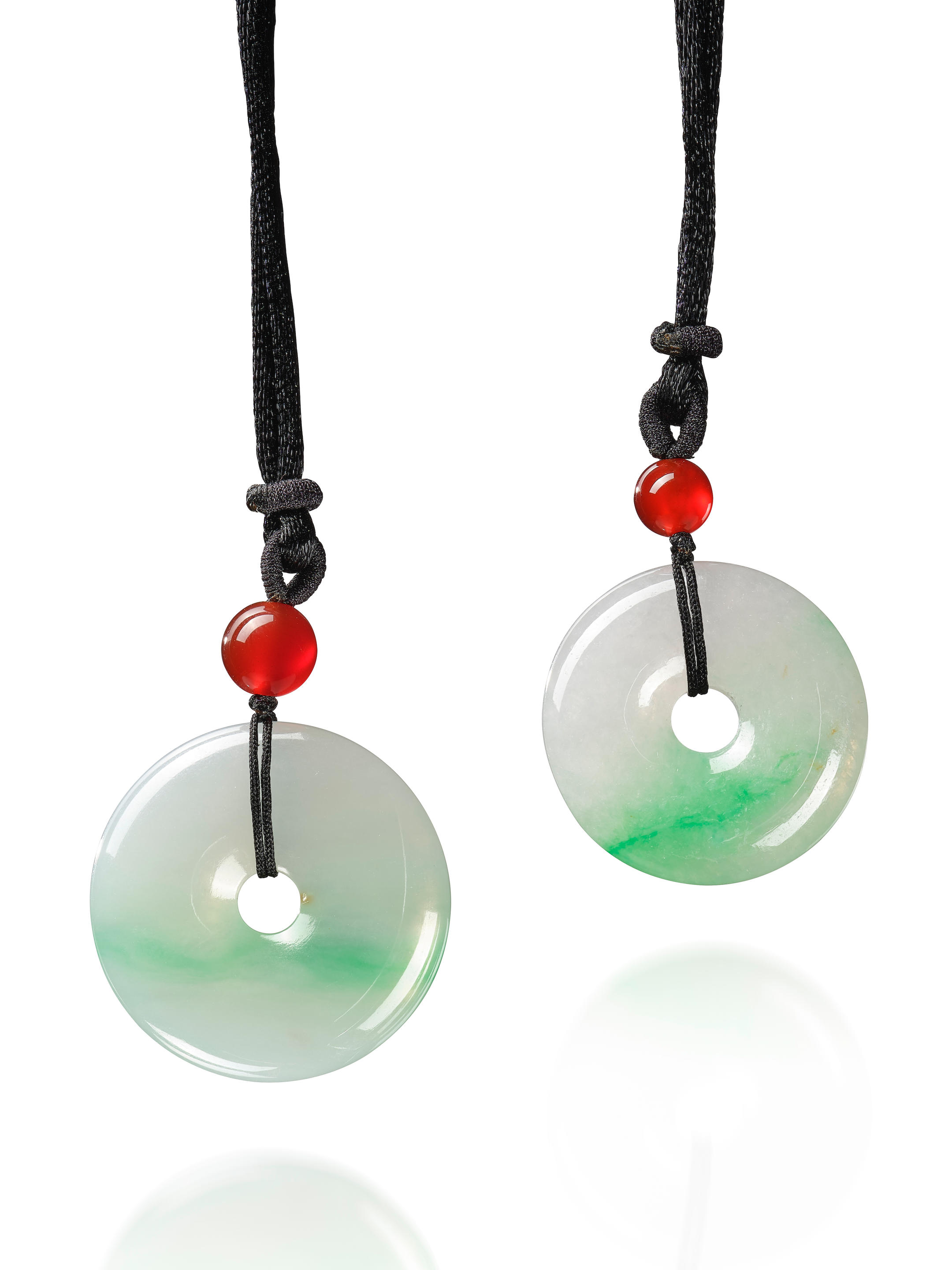 Appraisal: PAIR OF JADEITE 'HUAIGU' PENDANTS Each suspending a translucent jadeite