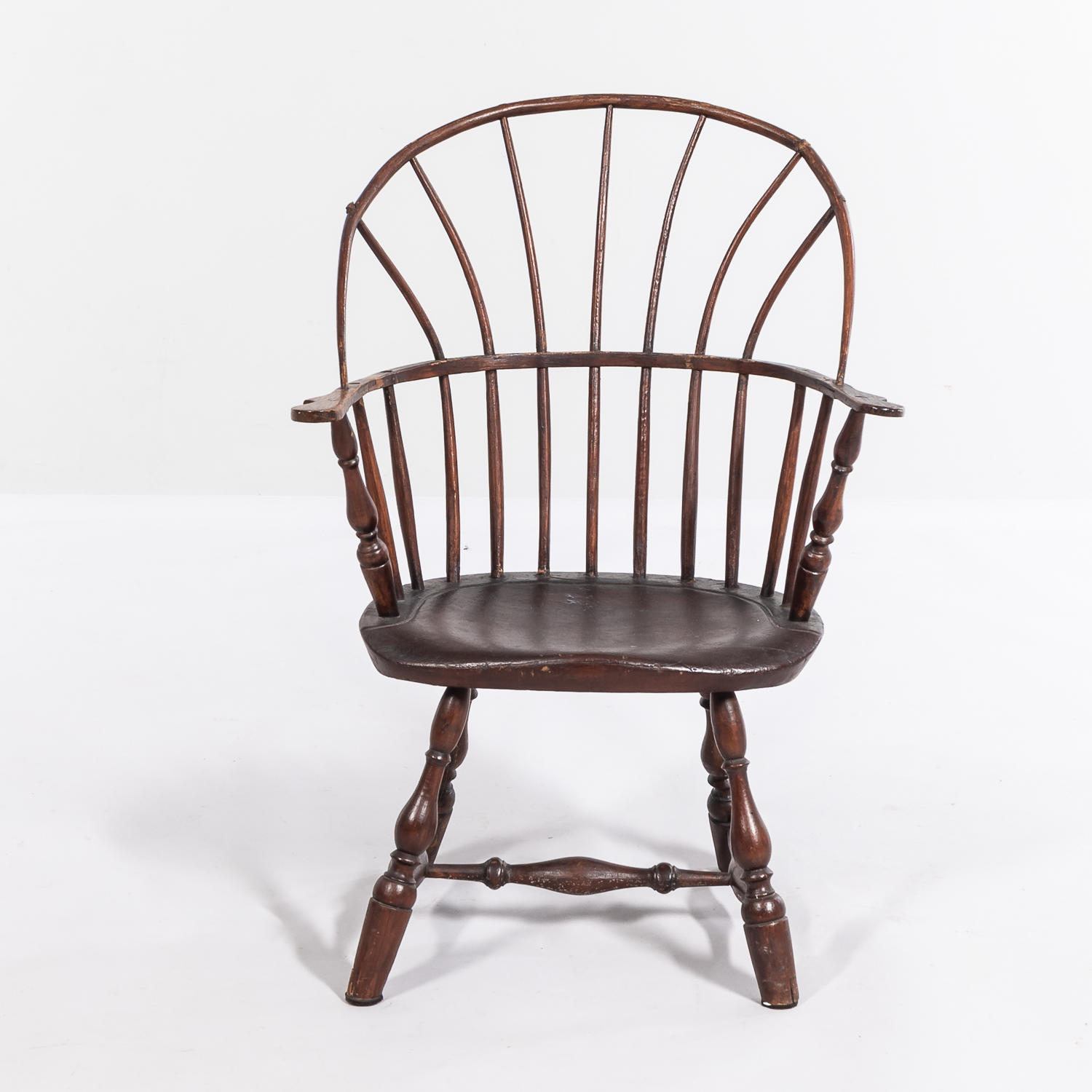 Appraisal: WINDSOR BROWN-PAINTED ARMCHAIR with turned legs bentwood spindles and carved