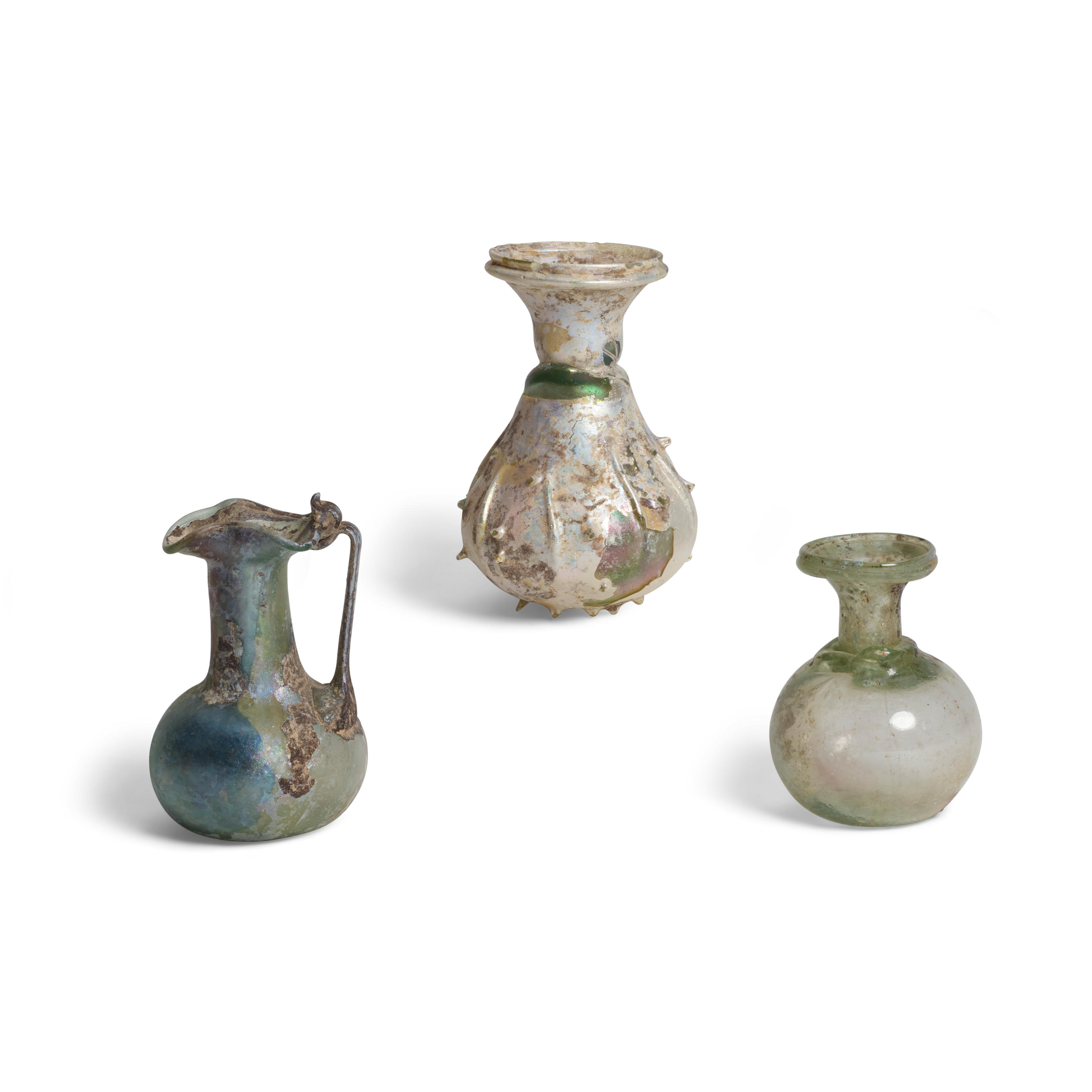 Appraisal: THREE ROMAN PALE GREEN GLASS VESSELS Circa nd- th century