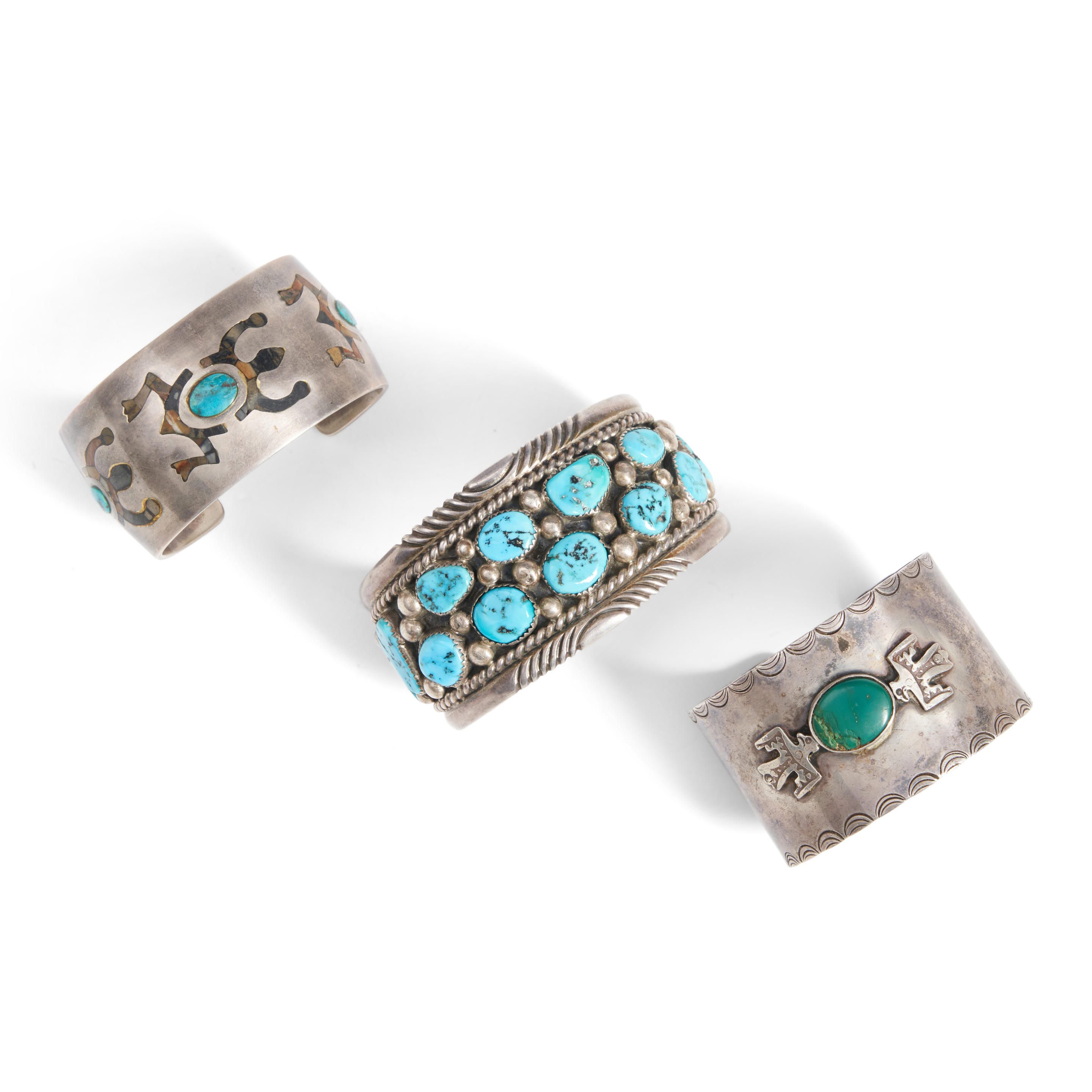 Appraisal: THREE SOUTHWEST SILVER AND TURQUOISE CUFF BRACELETS A wide silver