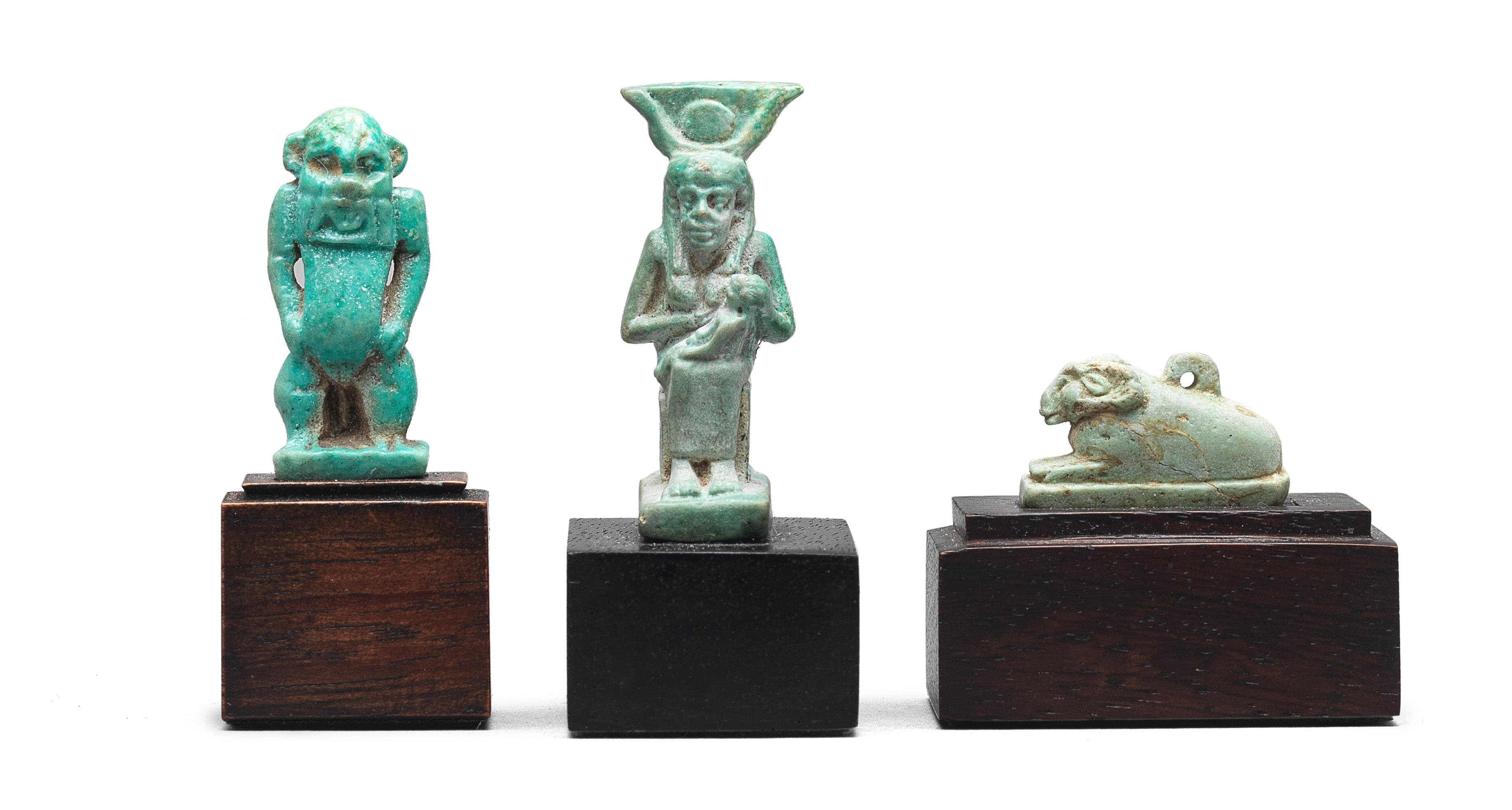 Appraisal: THREE EGYPTIAN FAIENCE AMULETS Three Egyptian faience amulets Late Period