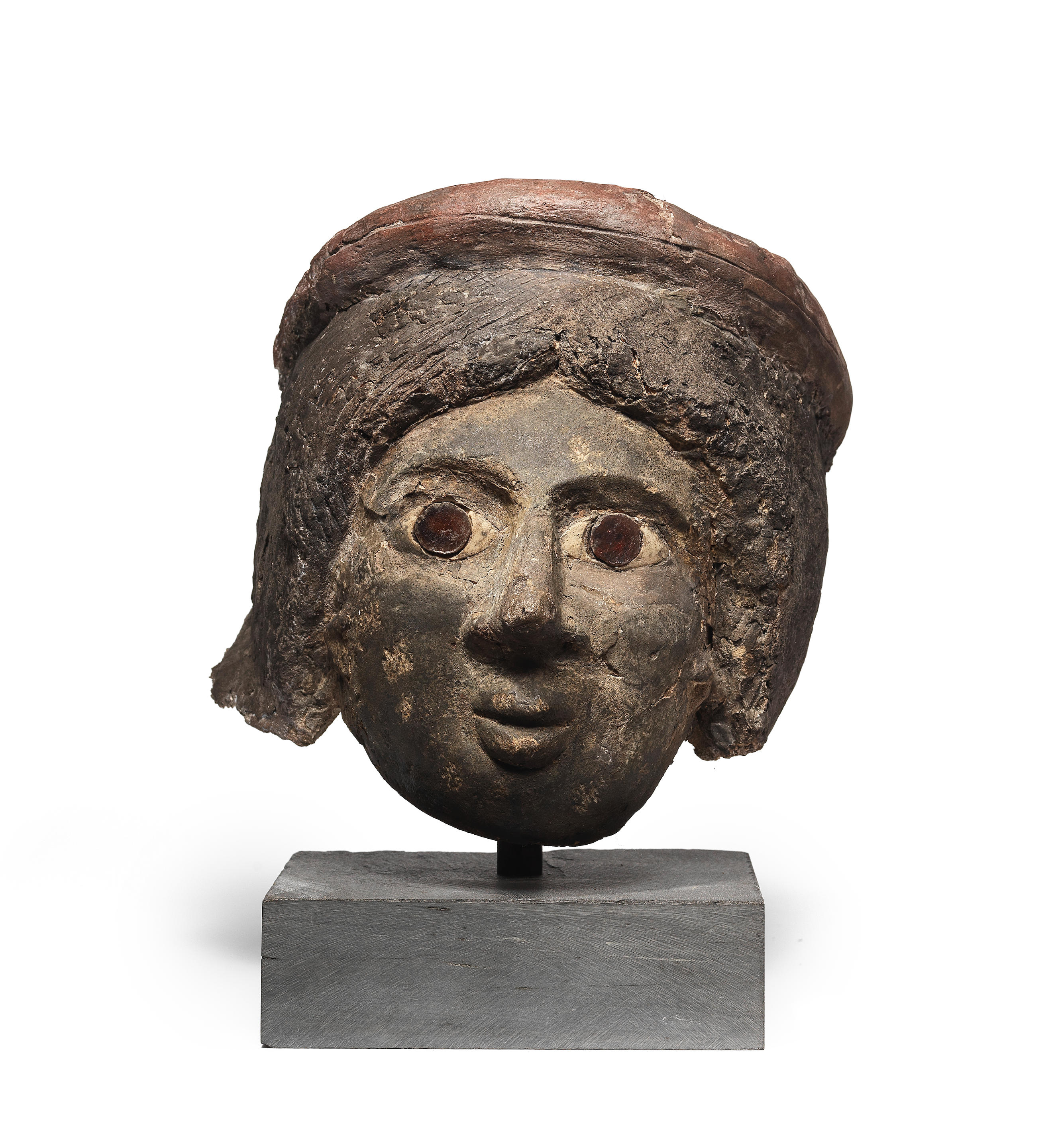 Appraisal: A ROMANO-EGYPTIAN PLASTER FUNERARY FEMALE HEAD A Romano-Egyptian plaster funerary