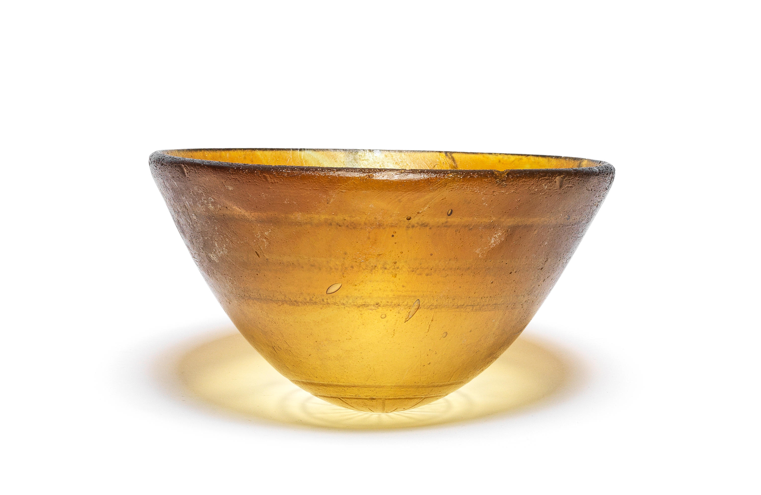 Appraisal: A HELLENISTIC CAST AMBER GLASS MAMMIFORM BOWL A Hellenistic cast