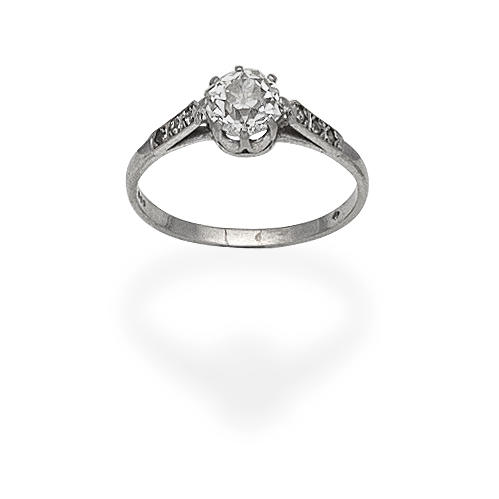 Appraisal: DIAMOND SINGLE-STONE RING Set with a cushion-shaped diamond between similarly