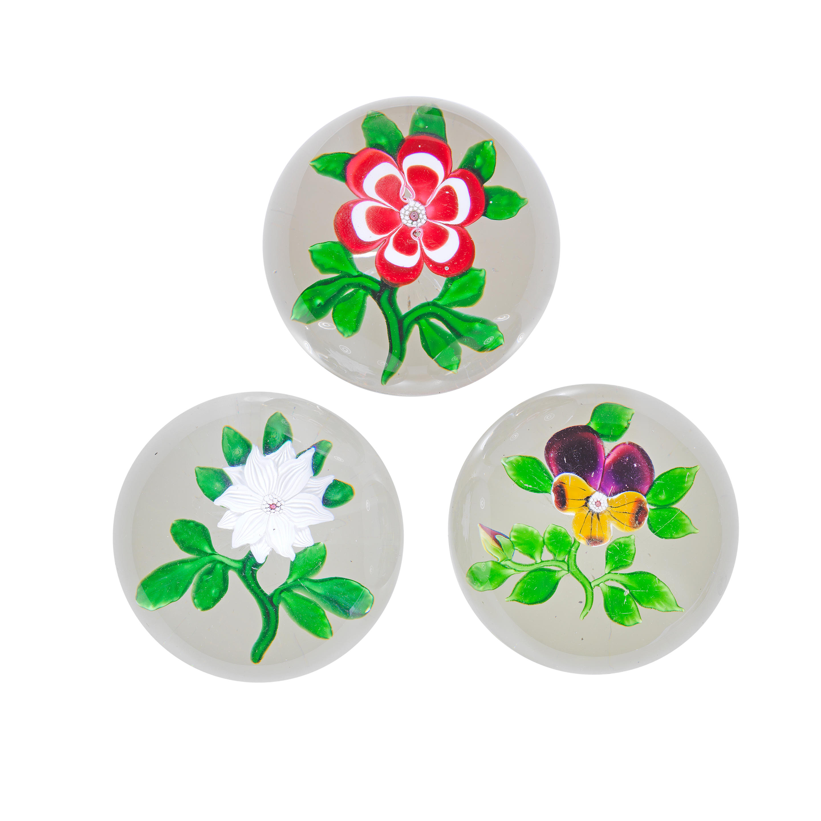 Appraisal: THREE BACCARAT FLOWER PAPERWEIGHTS CIRCA Set in clear glass and