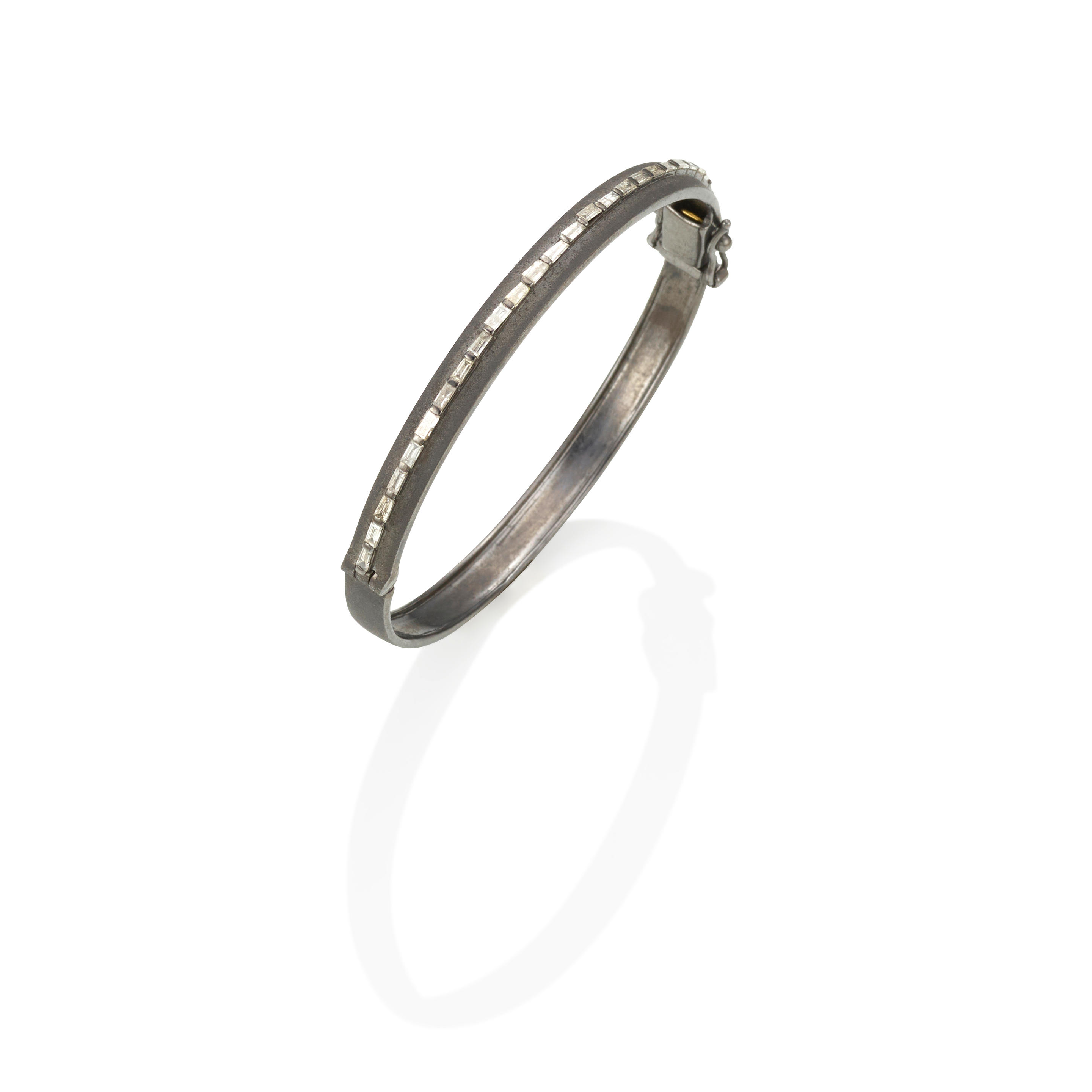 Appraisal: A SILVER AND DIAMOND HINGED BANGLE Diamonds estimated gross weight