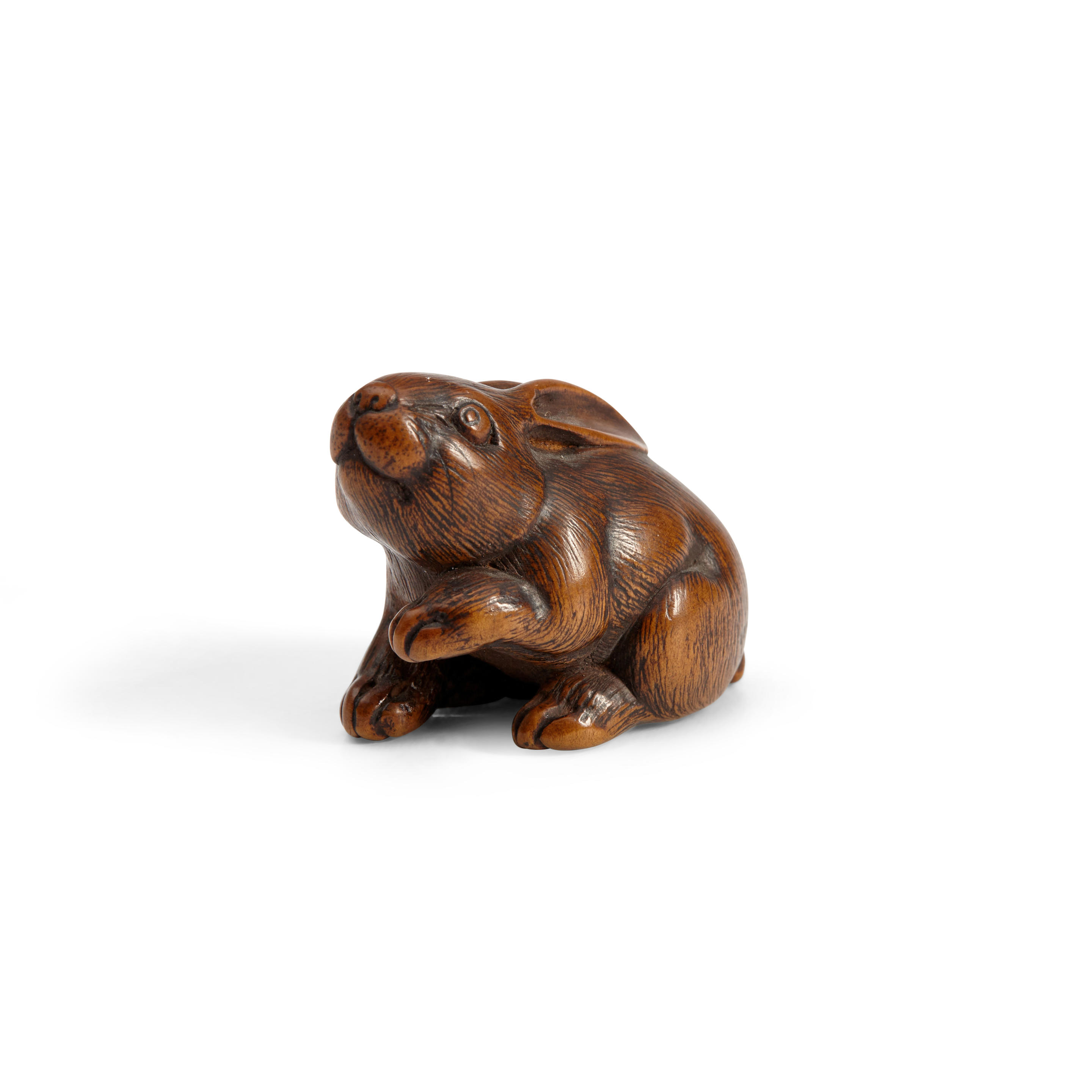 Appraisal: A WOOD NETSUKE OF A HARE Japan late Edo period