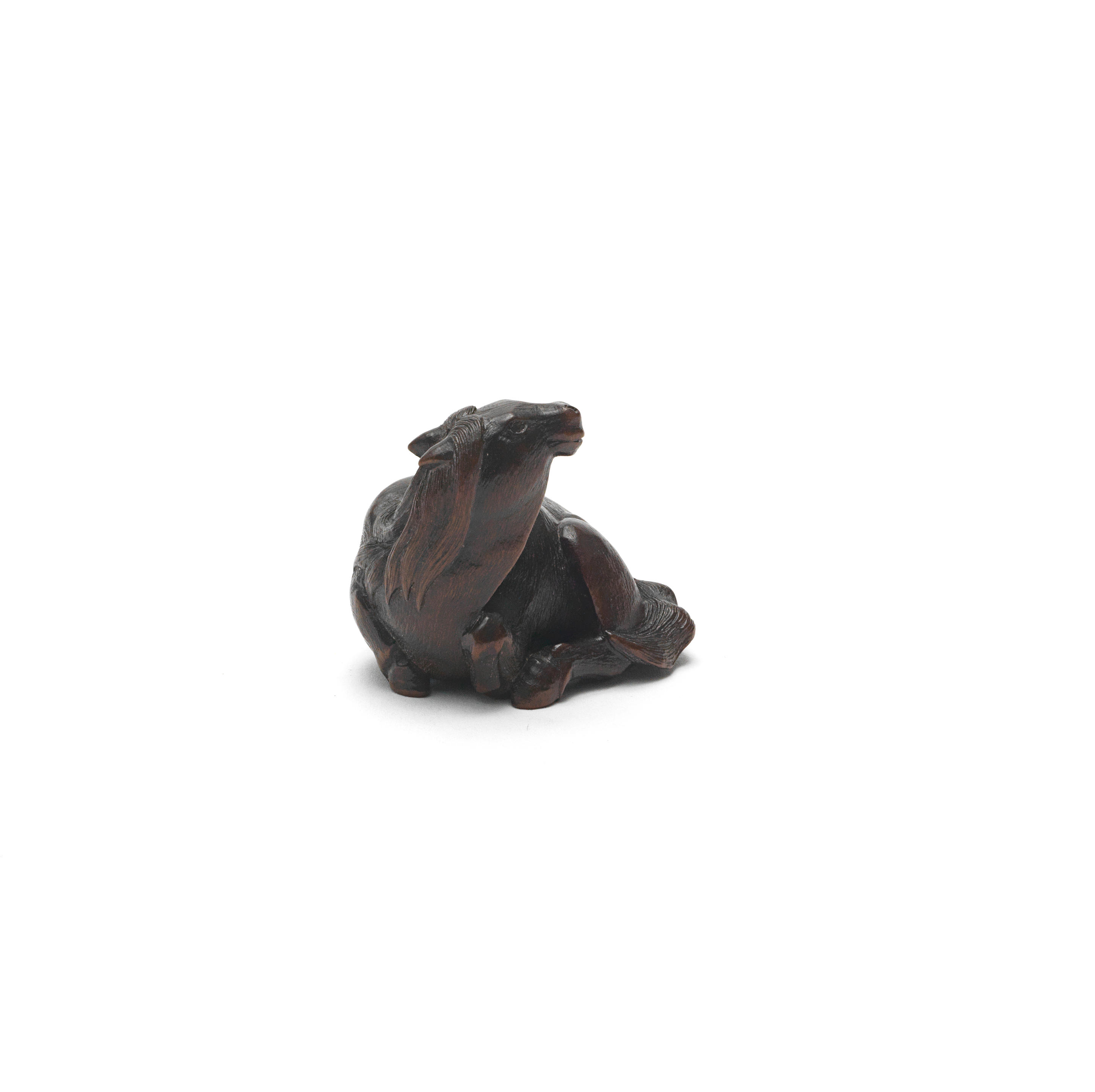 Appraisal: A WOOD NETSUKE OF A RECUMBENT HORSE Edo period -