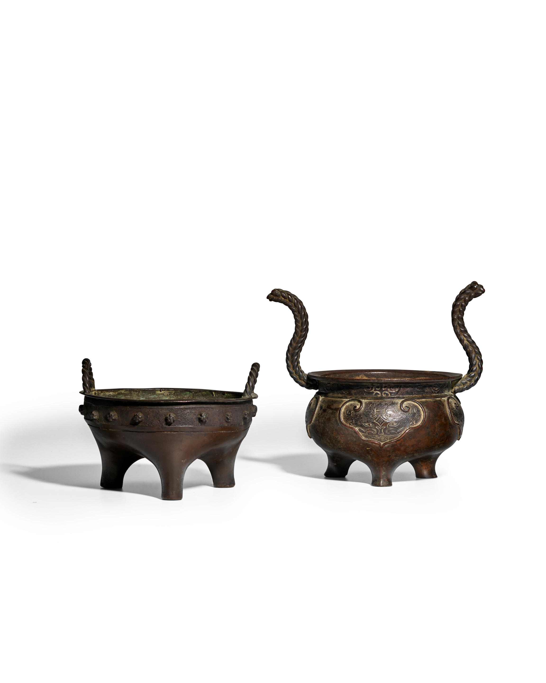 Appraisal: TWO ARCHAISTIC BRONZE TRIPOD CENSERS WITH ROPE HANDLES Ming Dynasty