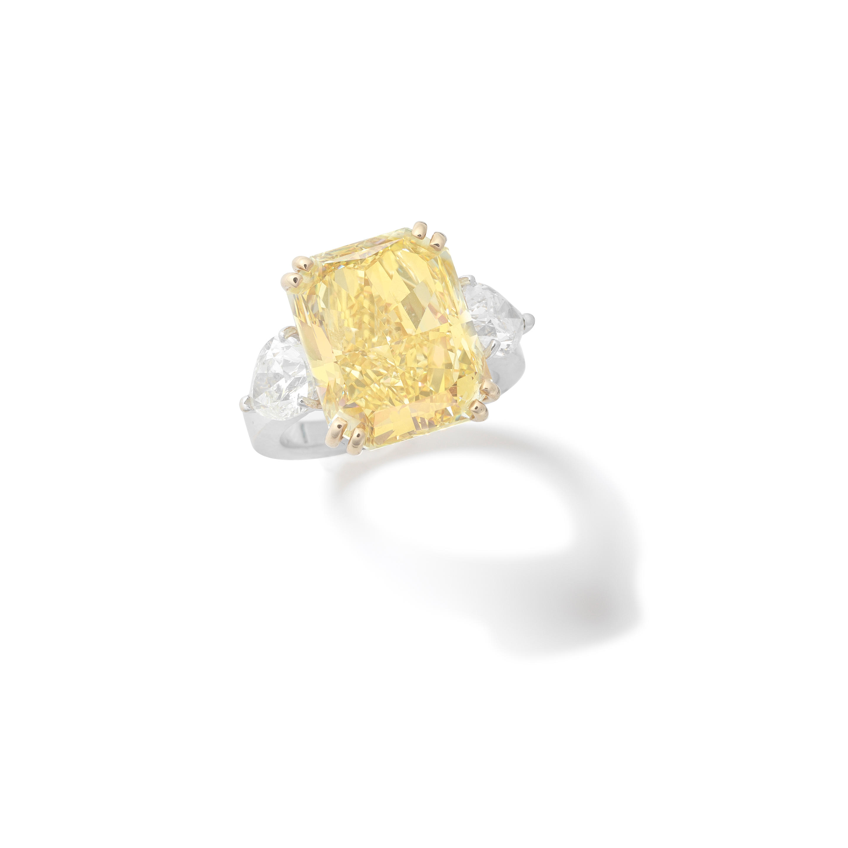 Appraisal: DIAMOND AND COLOURED DIAMOND RING The radiant-cut Fancy Yellow diamond