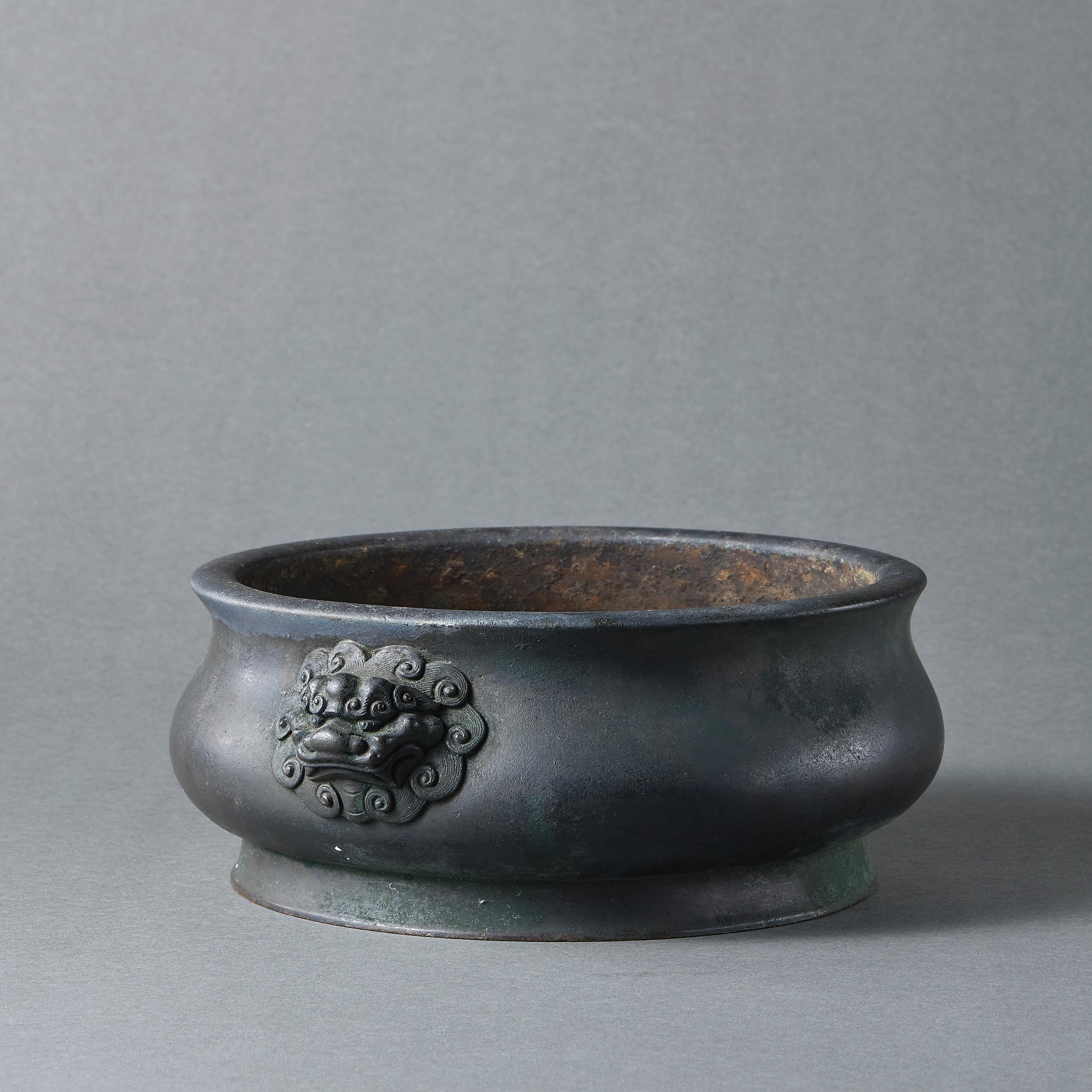 Appraisal: A BRONZE 'LION MASK'-HANDLED INCENSE BURNER Cast Xuande six-character mark