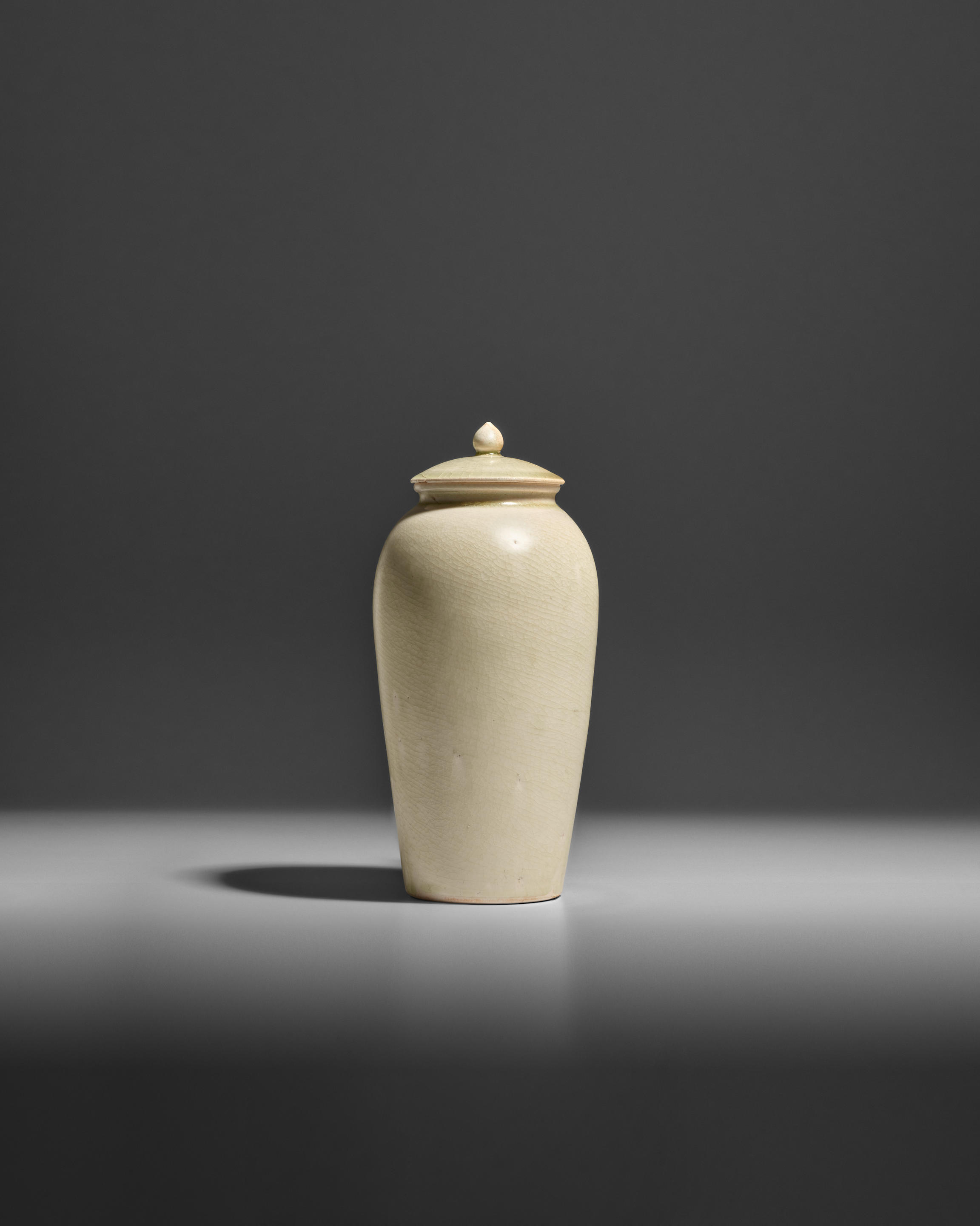 Appraisal: A GLAZED WHITE STONEWARE JAR AND COVER Sui dynasty Rising