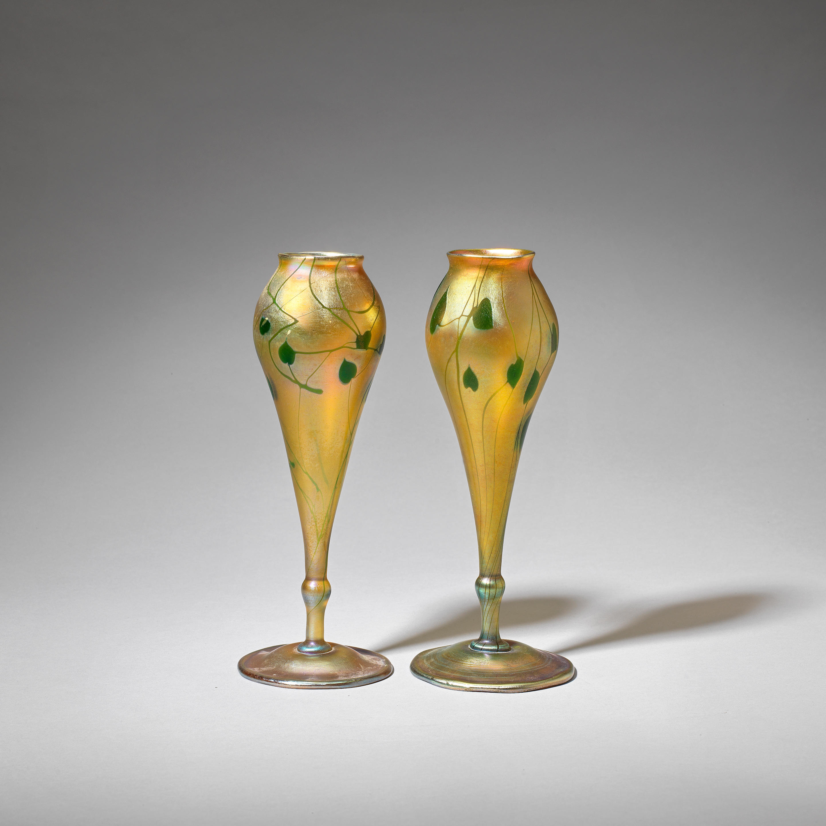 Appraisal: LOUIS COMFORT TIFFANY Near pair of 'Favrile' vases Iridescent glass