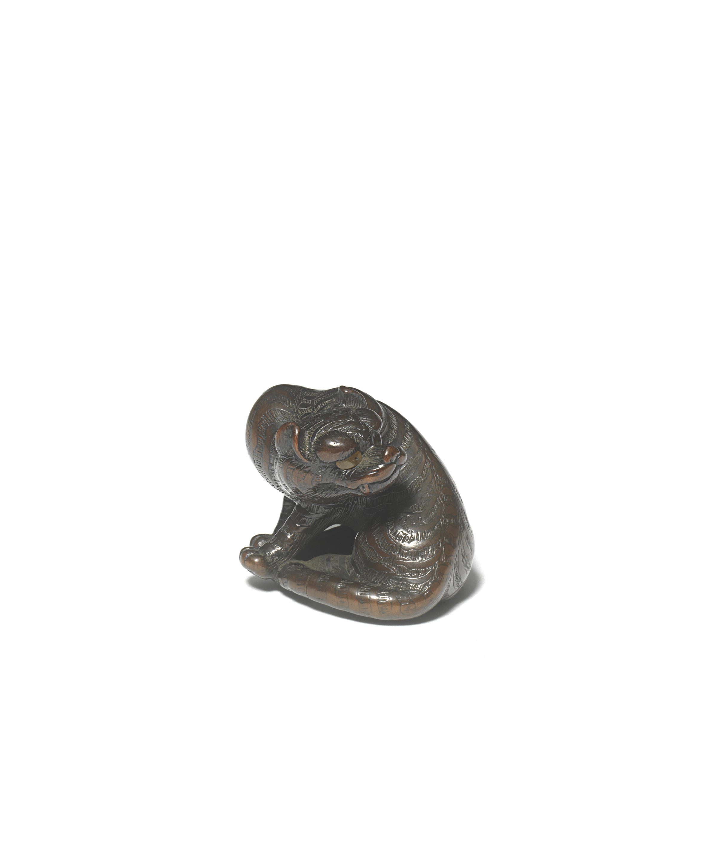 Appraisal: A WOOD NETSUKE OF A TIGER By Naito Toyomasa -