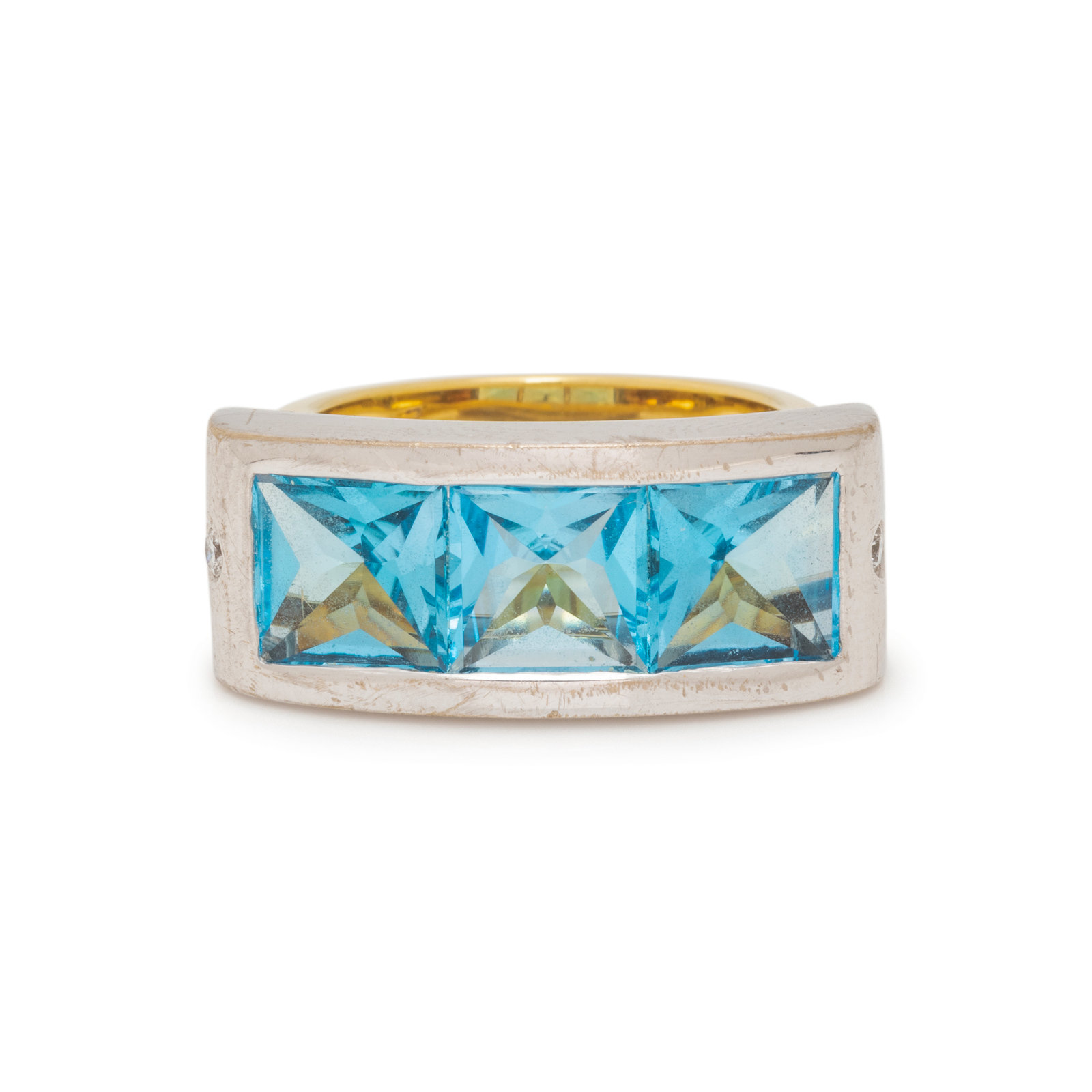 Appraisal: BICOLOR GOLD BLUE TOPAZ AND DIAMOND RING Containing three square