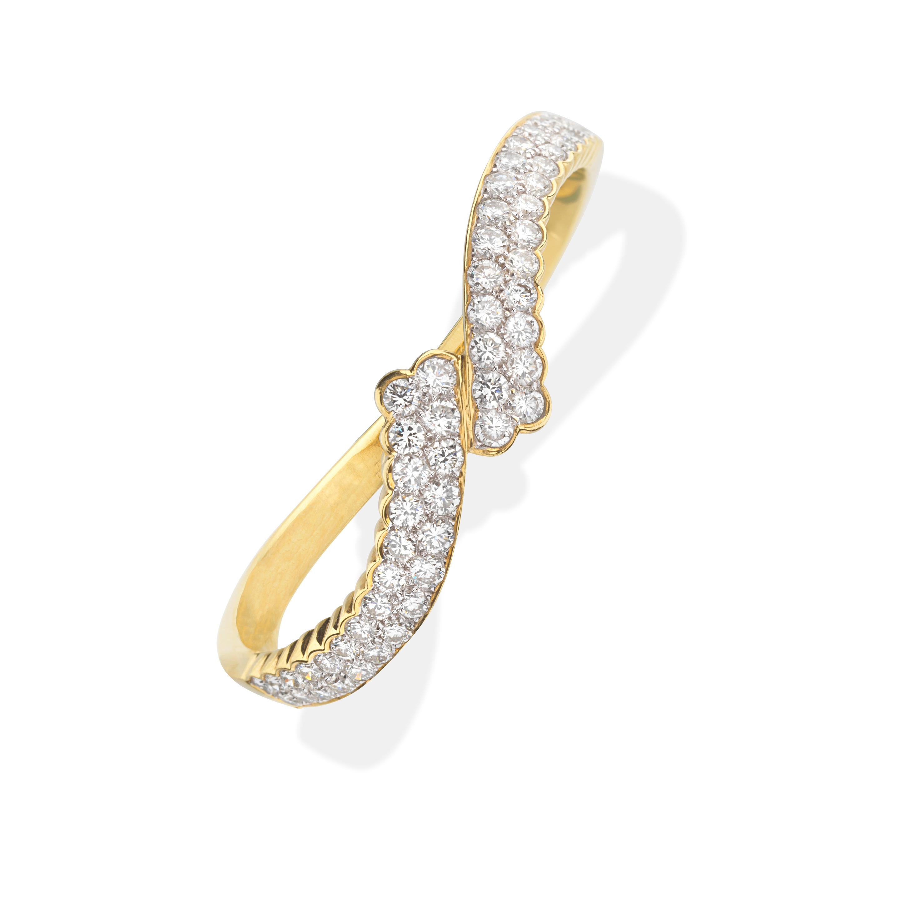 Appraisal: DIAMOND BANGLE The hinged bangle of crossover design set to