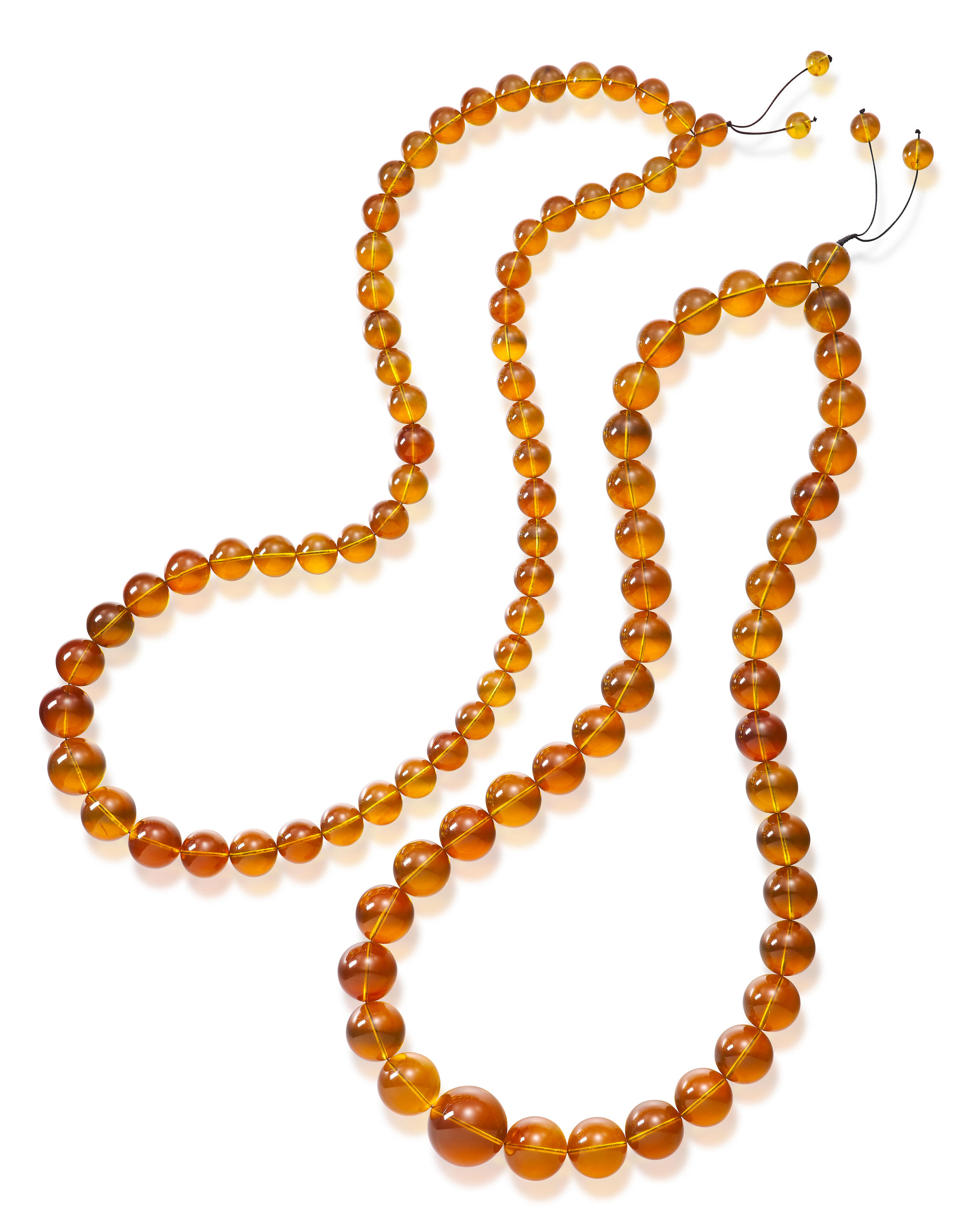 Appraisal: TWO AMBER BEAD NECKLACES Certificates GIA selected ambers and February