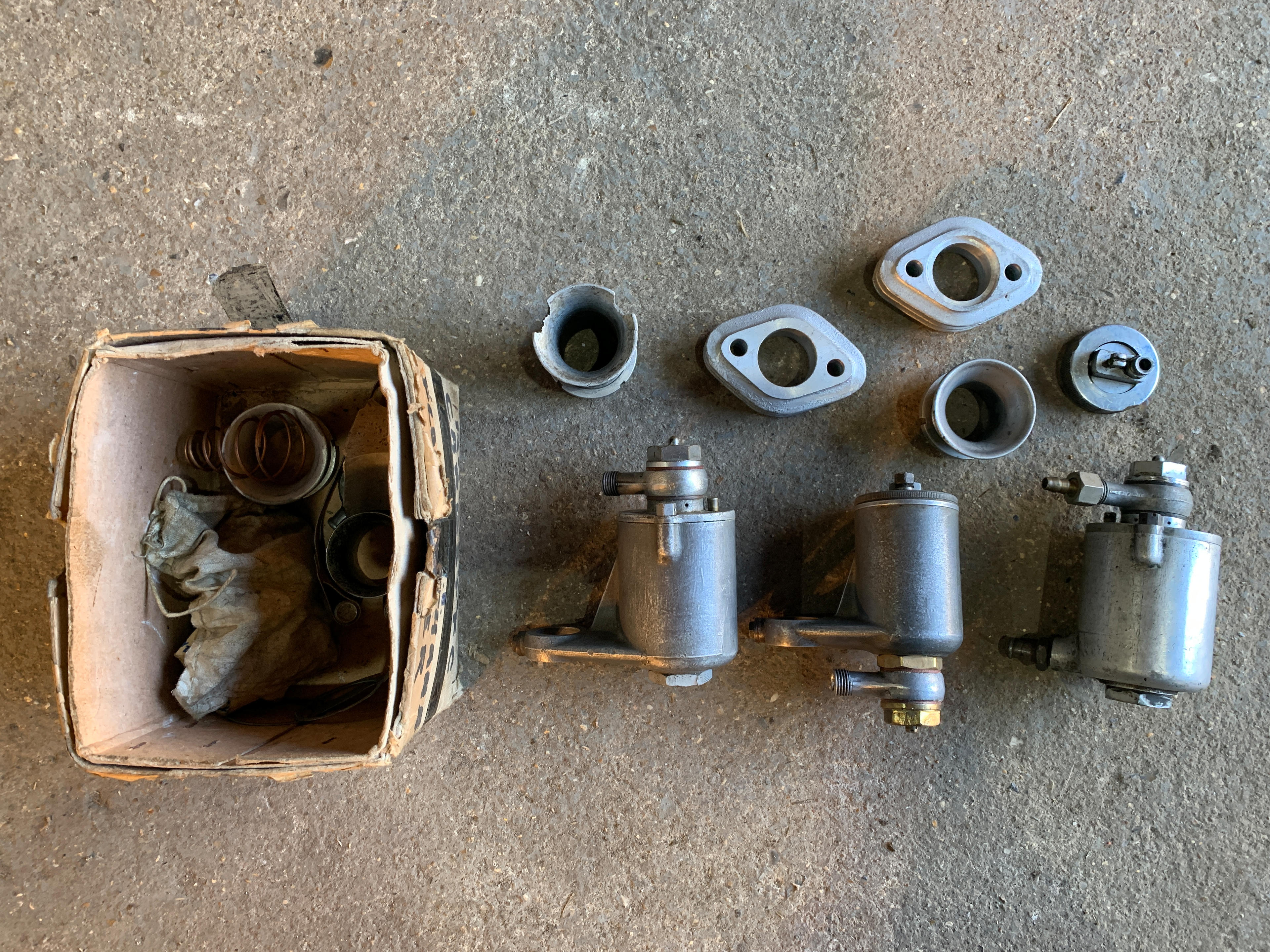 Appraisal: THREE AMAL FLOAT CHAMBER RACING TYPE ASSEMBLIES and assorted carburettor