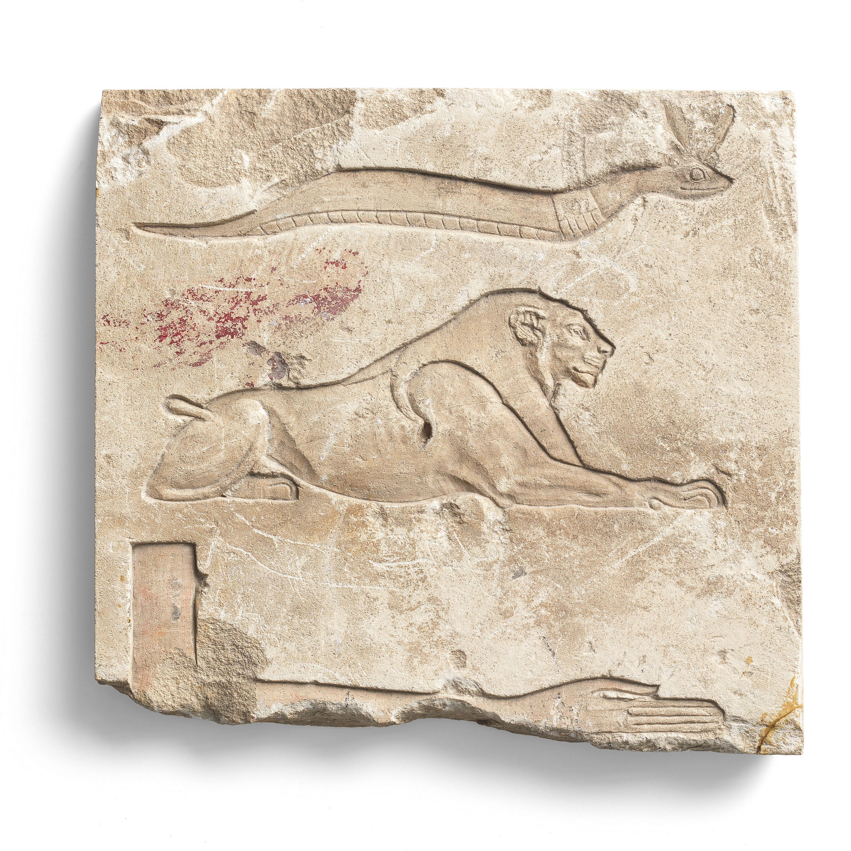 Appraisal: AN EGYPTIAN LIMESTONE RELIEF FRAGMENT WITH LION HIEROGLYPH An Egyptian