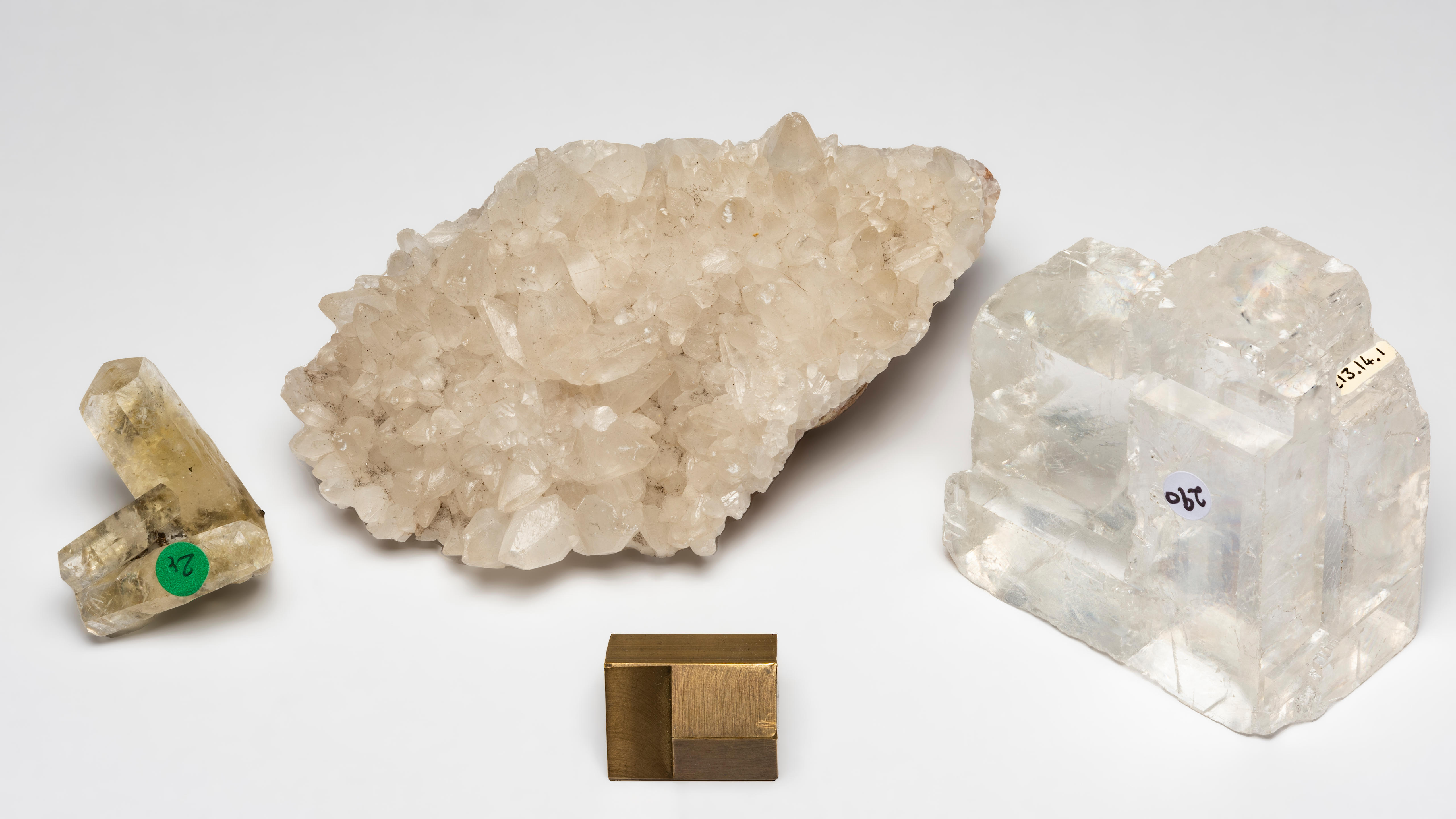 Appraisal: TWO CALCITES AND ICELAND SPAR Calcite Three golden translucent double