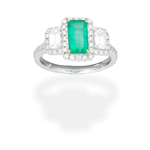 Appraisal: EMERALD AND DIAMOND RING The step-cut emerald between step-cut diamonds