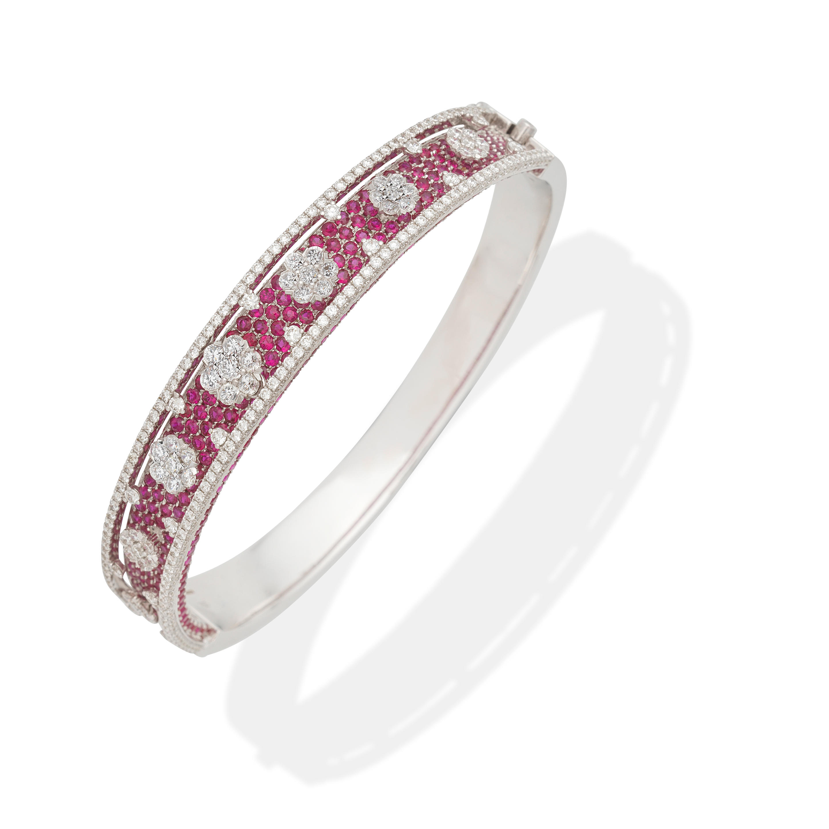 Appraisal: RUBY AND DIAMOND BANGLE Hinged bangle Of tiered design Circular-cut