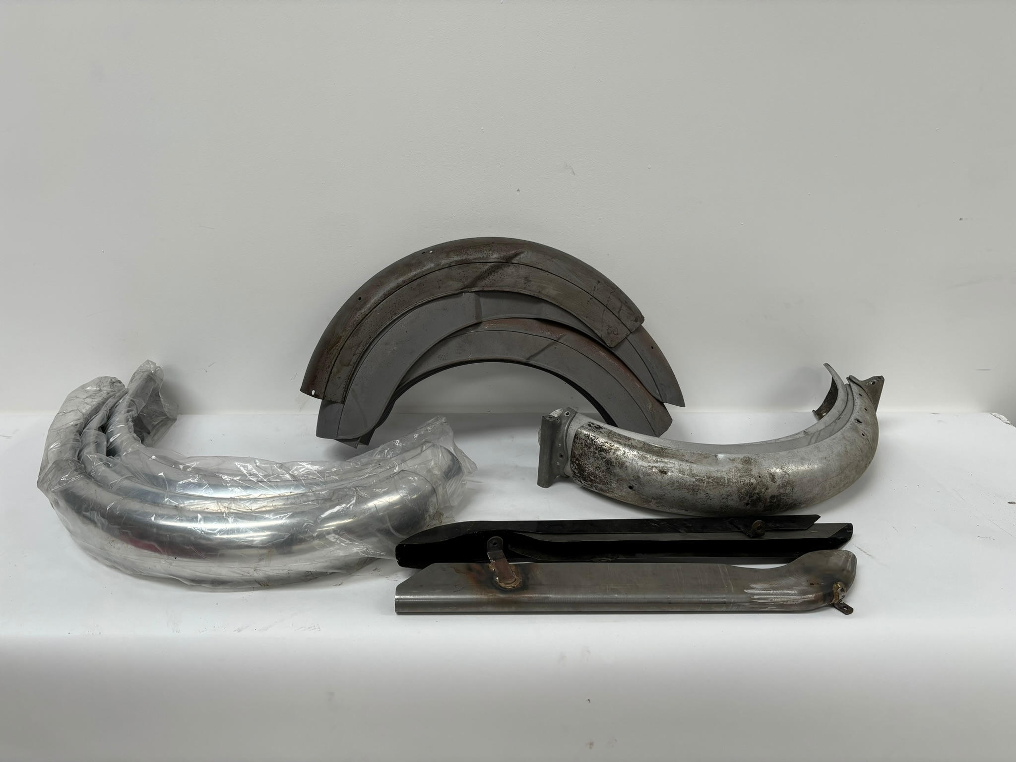 Appraisal: A QUANTITY OF MUDGUARDS including Alloy and Steel types together