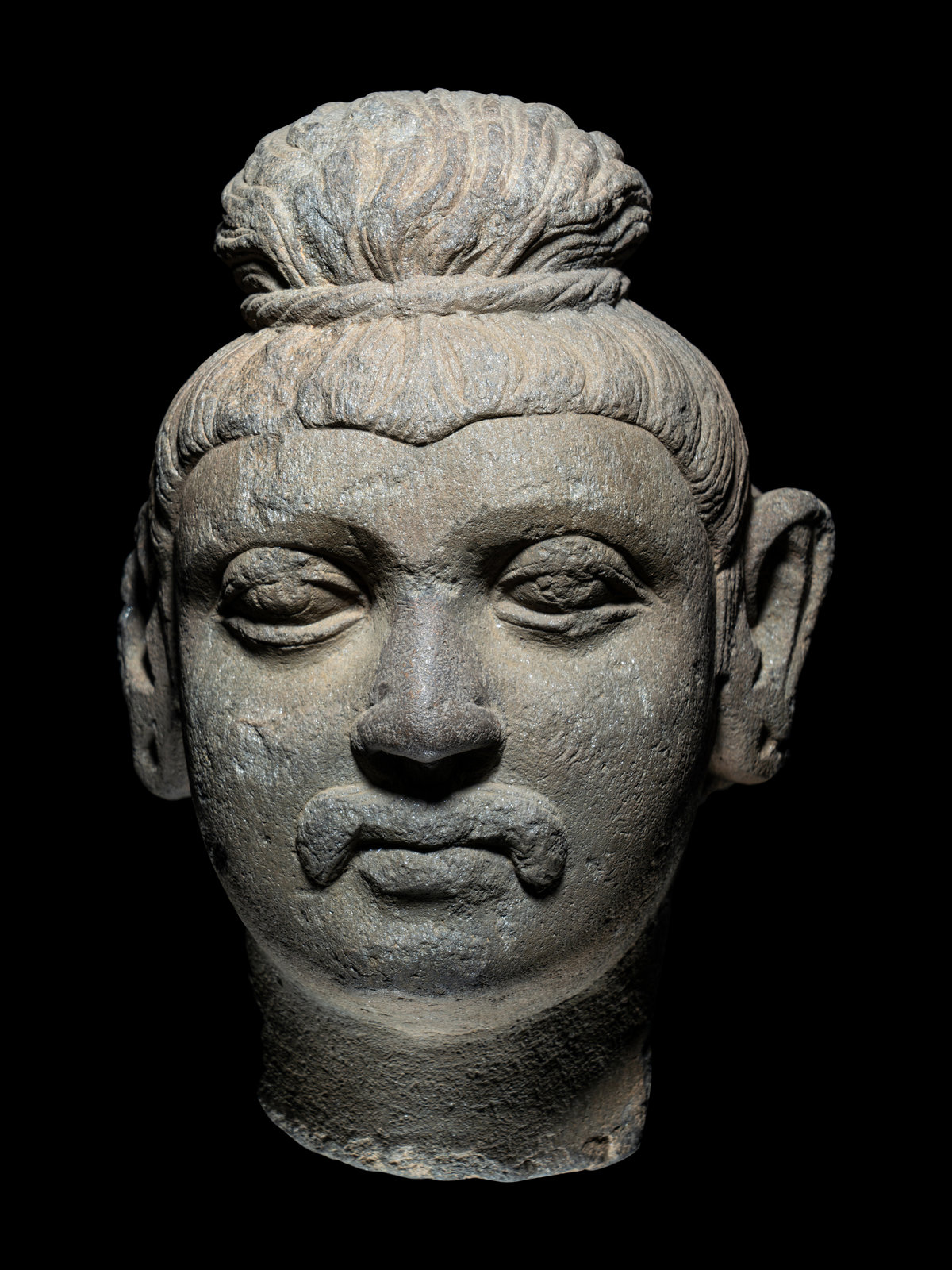 Appraisal: A Gandhran Sandstone Head of Buddha the face with downcast