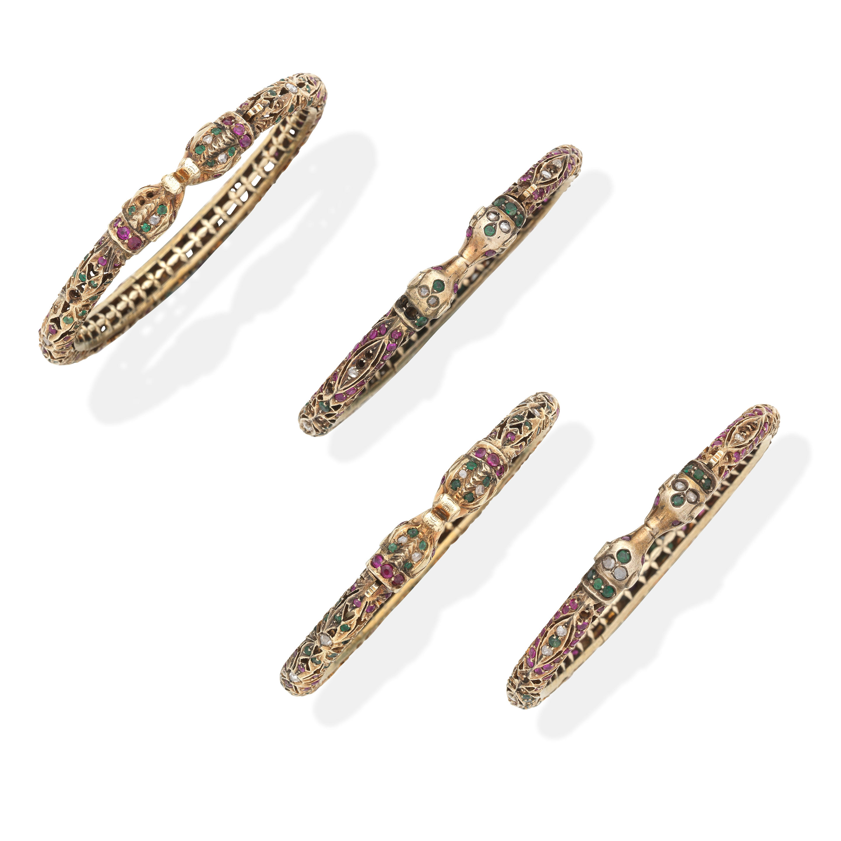 Appraisal: FOUR GEM-SET BANGLES Each hinged bangle designed as two opposing