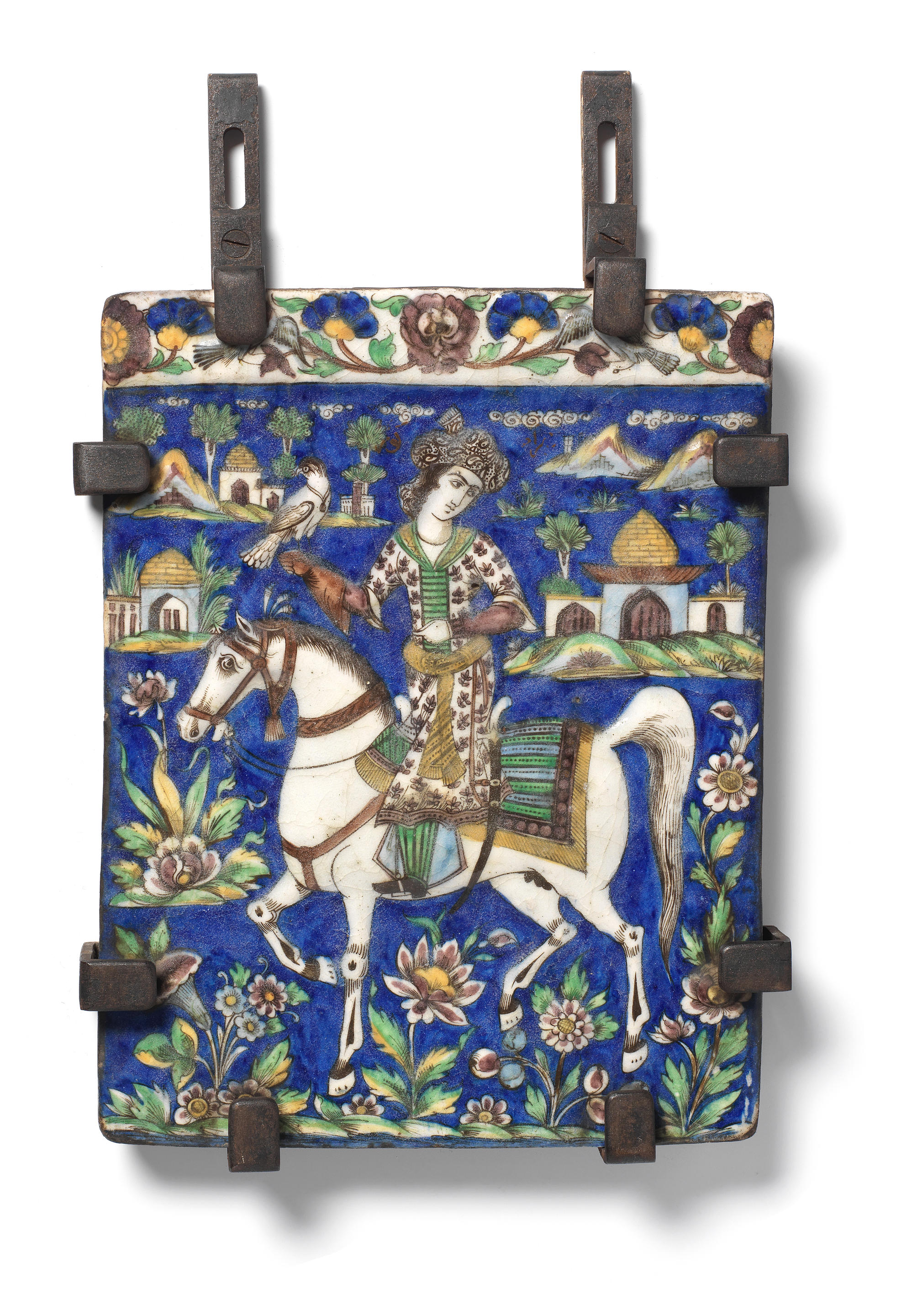 Appraisal: A QAJAR UNDERGLAZE-PAINTED MOULDED POTTERY TILE DEPICTING A YOUTH OUT