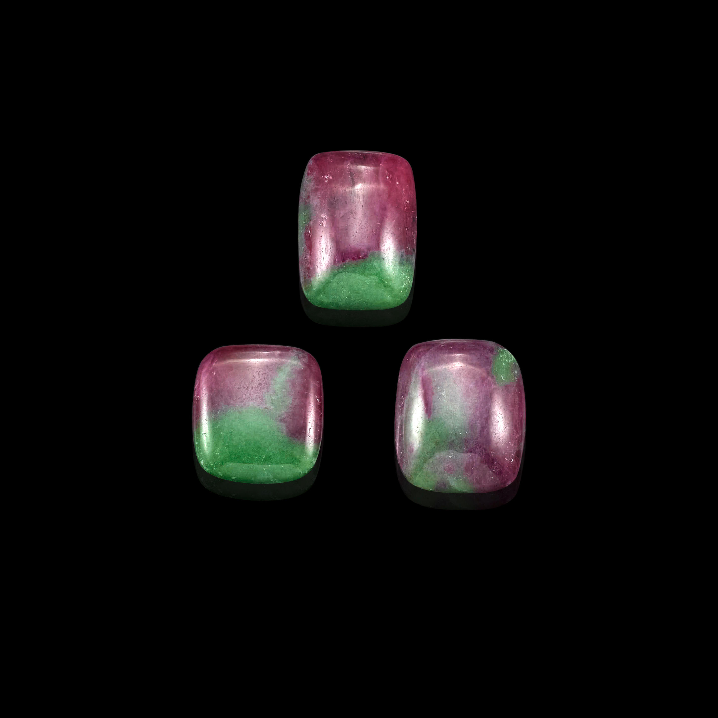 Appraisal: THREE RUBY-IN-ZOISITE CABOCHONS Three cushion-shaped ruby-in-zoisite cabochons each weighing approximately