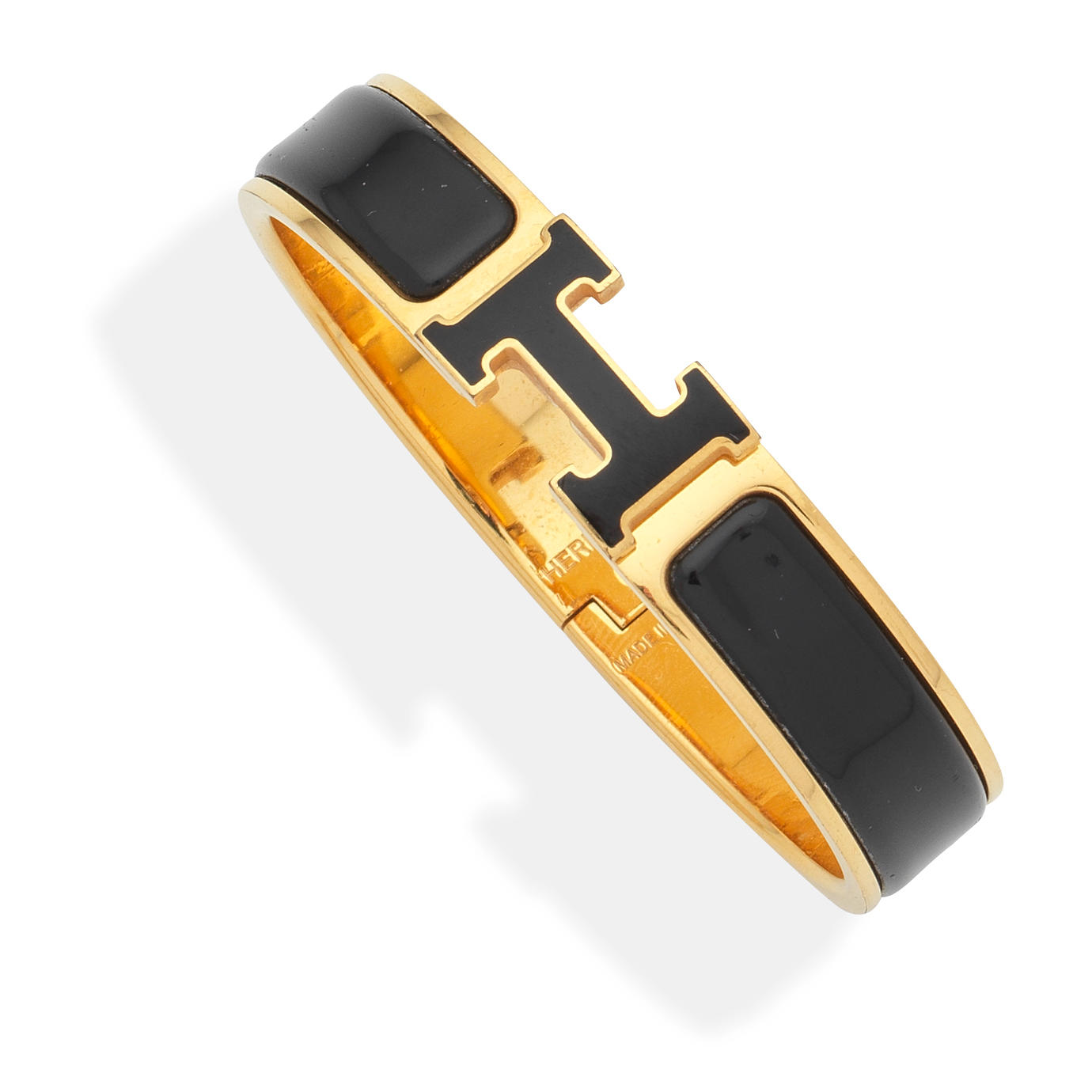 Appraisal: HERM S A BLACK CLIC H BRACELET Gold metal with