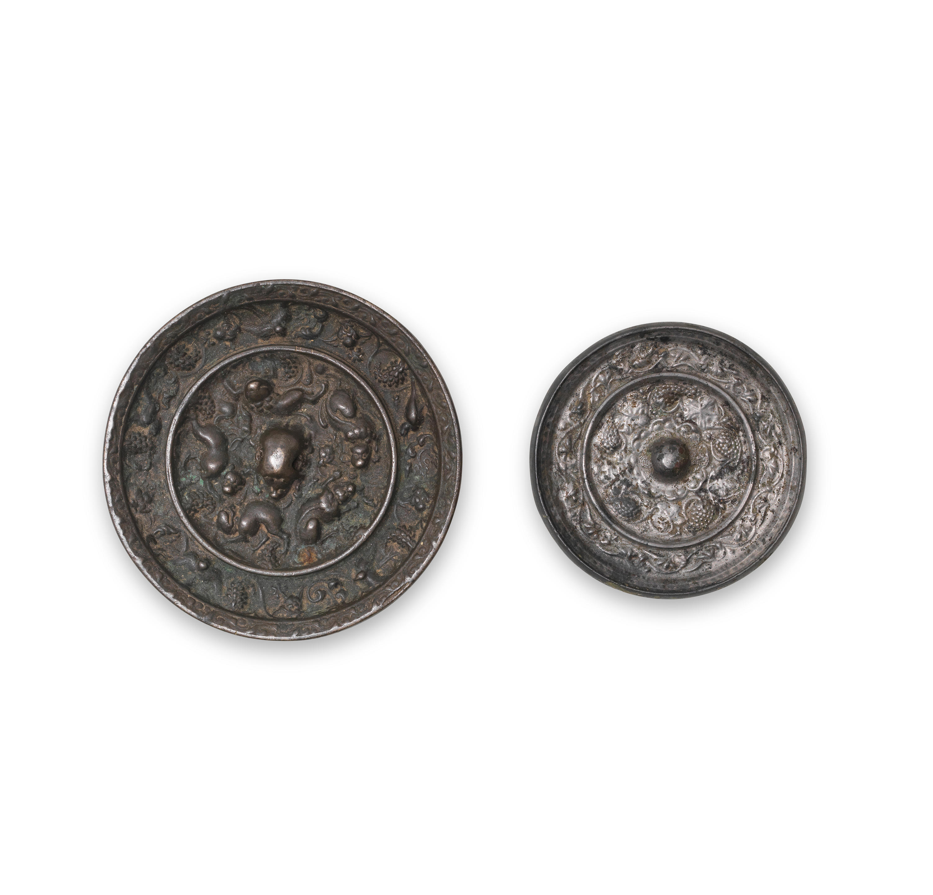 Appraisal: TWO BRONZE 'LION AND GRAPEVINE' MIRRORS Tang Dynasty The larger