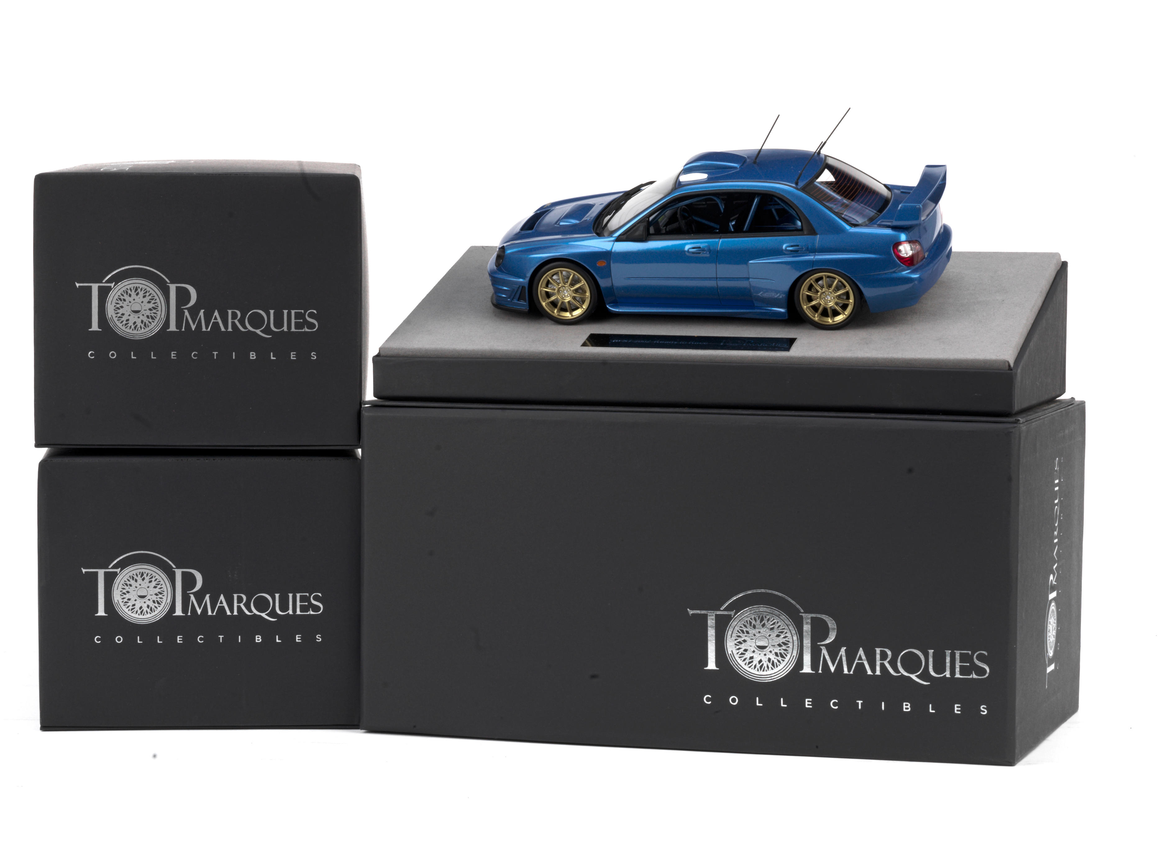 Appraisal: THREE BOXED SCALE MODELS BY TOP MARQUES comprising Subaru S