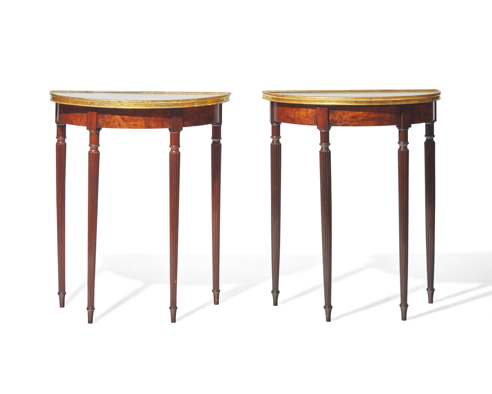 Appraisal: A pair of George III parcel-gilt mahogany demilune console tables