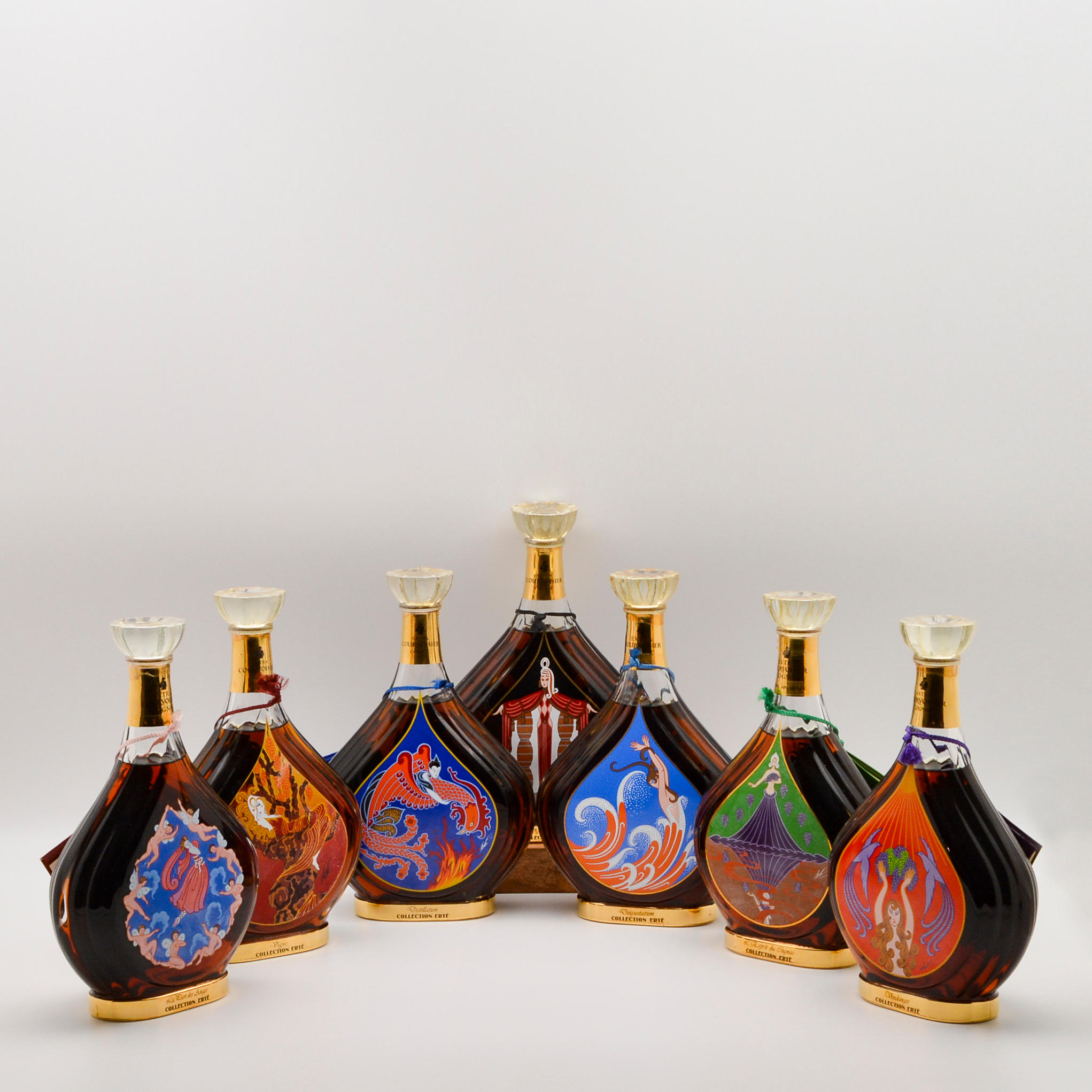 Appraisal: COURVOISIER ERTE SET BOTTLES Courvoisier Erte Set bottles Courvoisier Erte