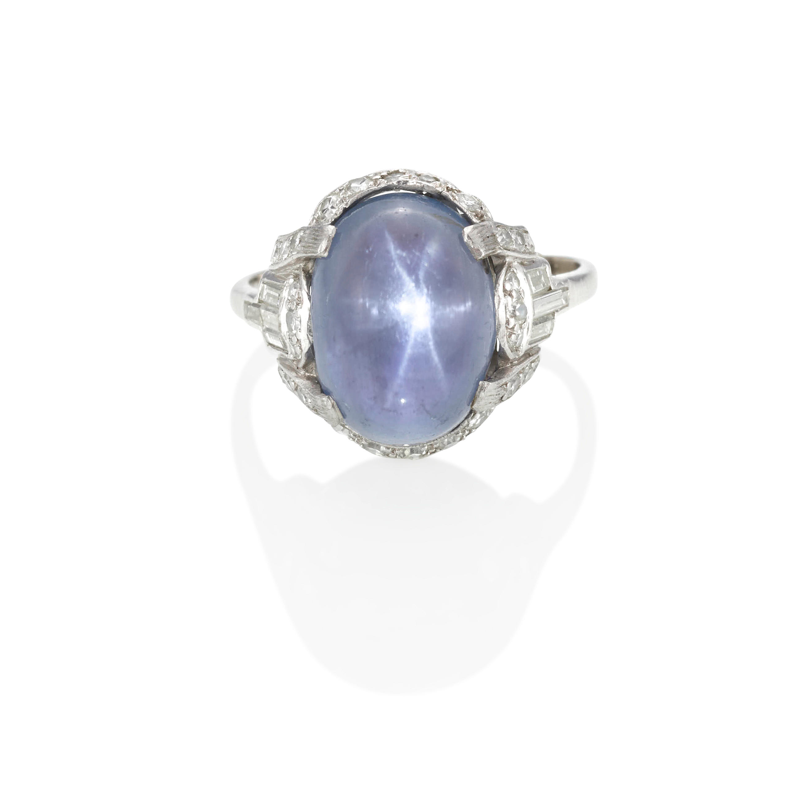 Appraisal: A PLATINUM STAR SAPPHIRE AND DIAMOND RING Centering an oval