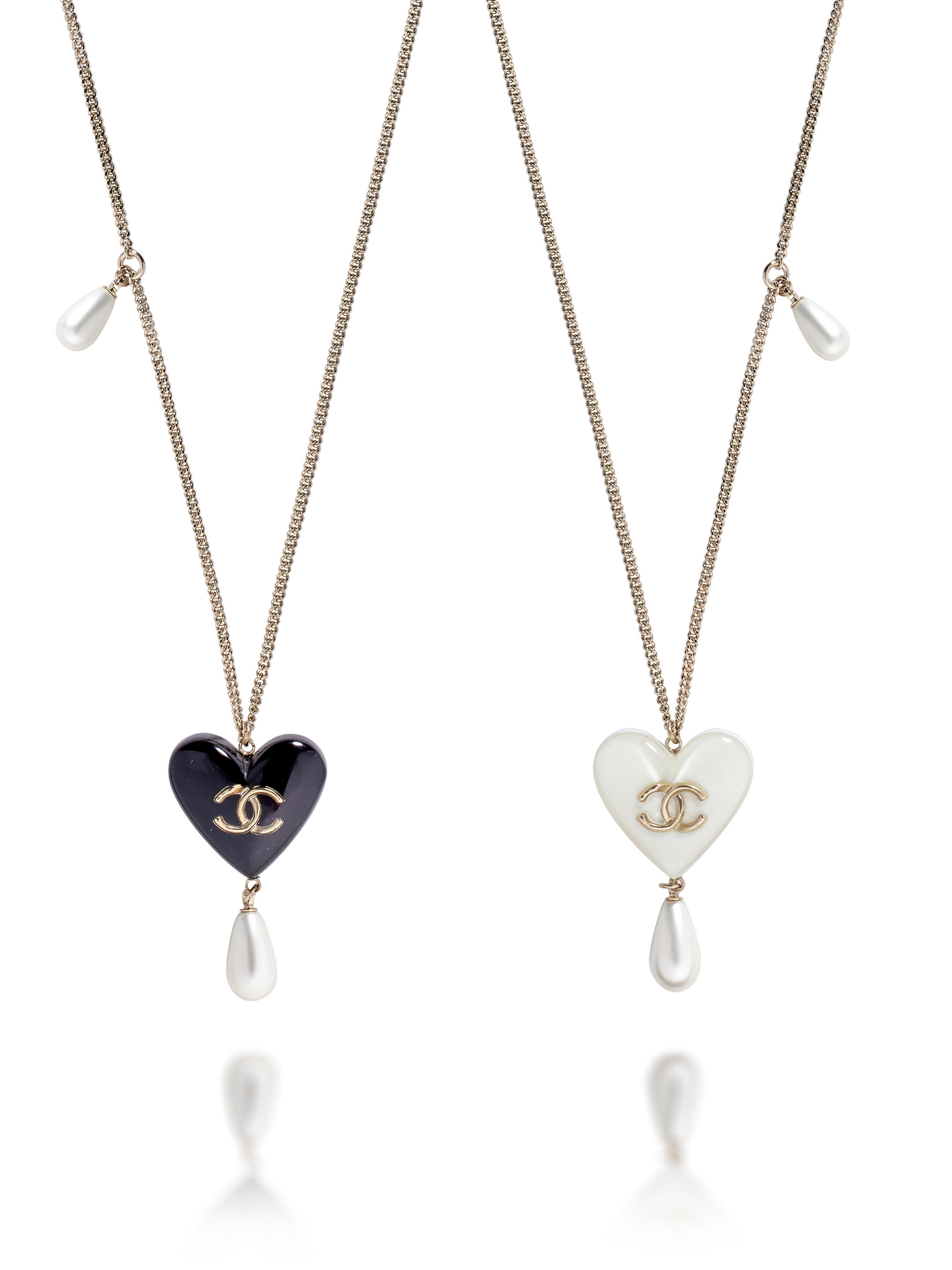 Appraisal: CHANEL WHITE AND BLACK HEART PENDANTS NECKLACE IN GOLD TONED