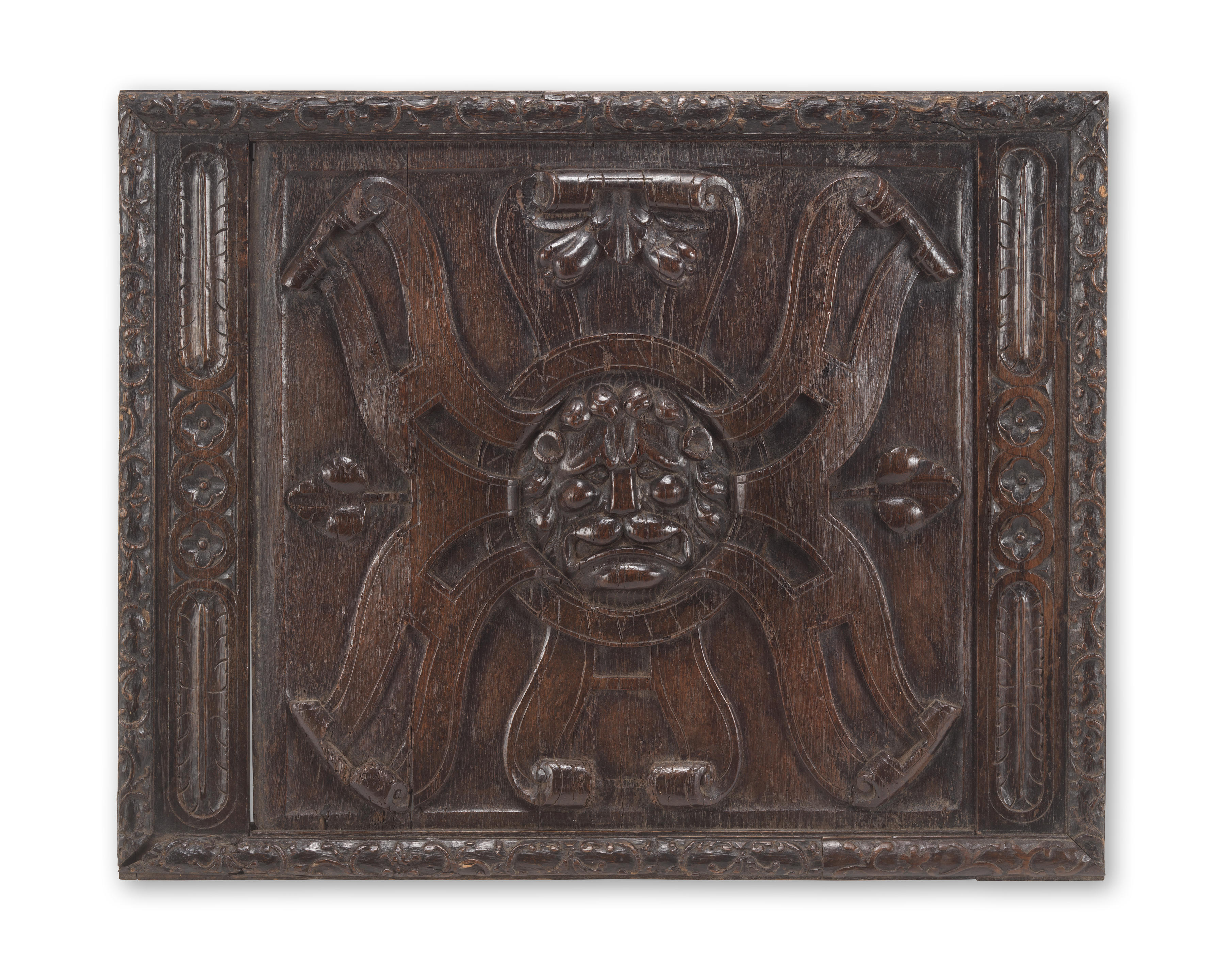 Appraisal: A CARVED OAK LIONS MASK AND ROUNDEL RECTANGULAR PANEL probably