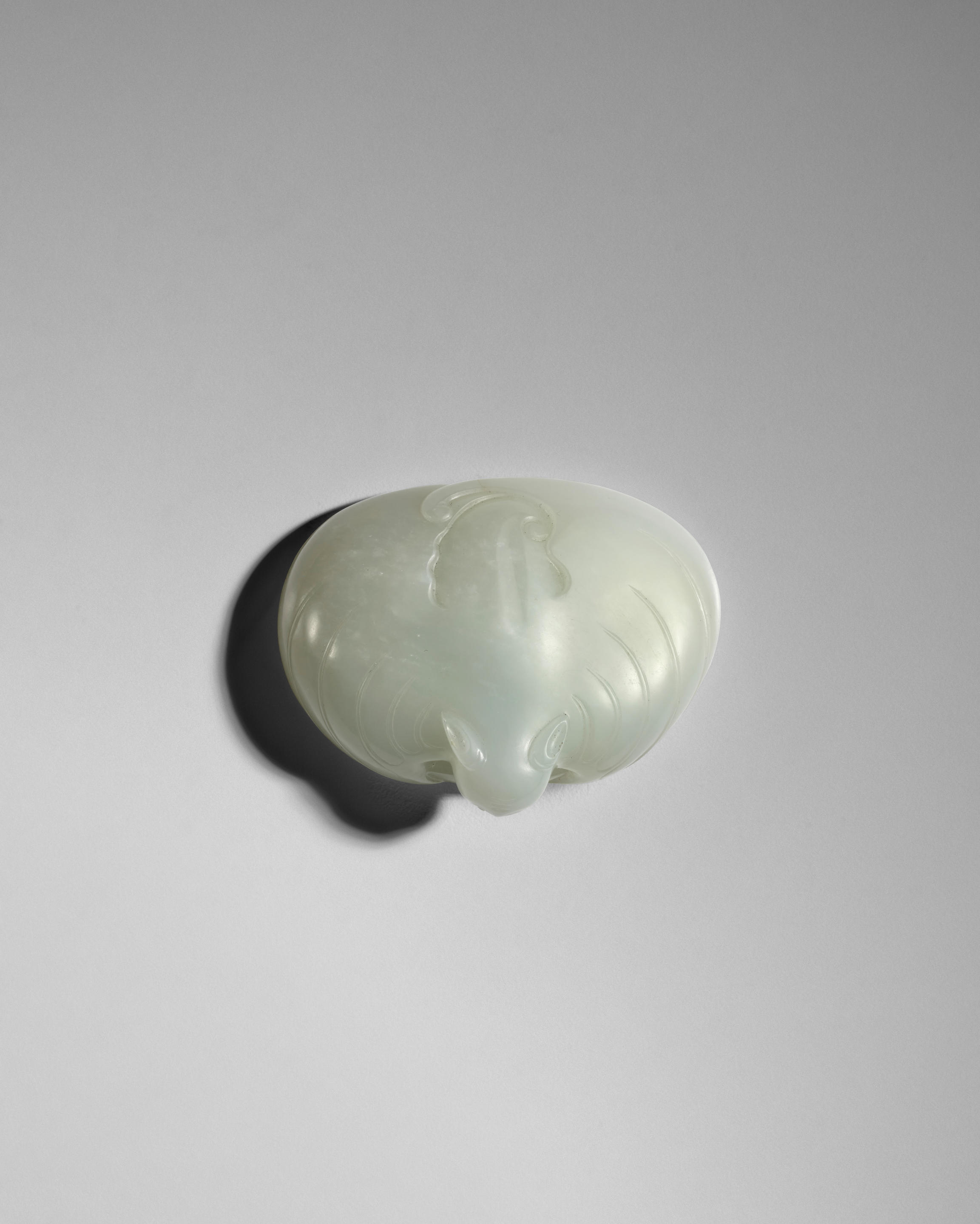 Appraisal: A WHITE JADE CARVING OF 'BAT AND COIN' late th